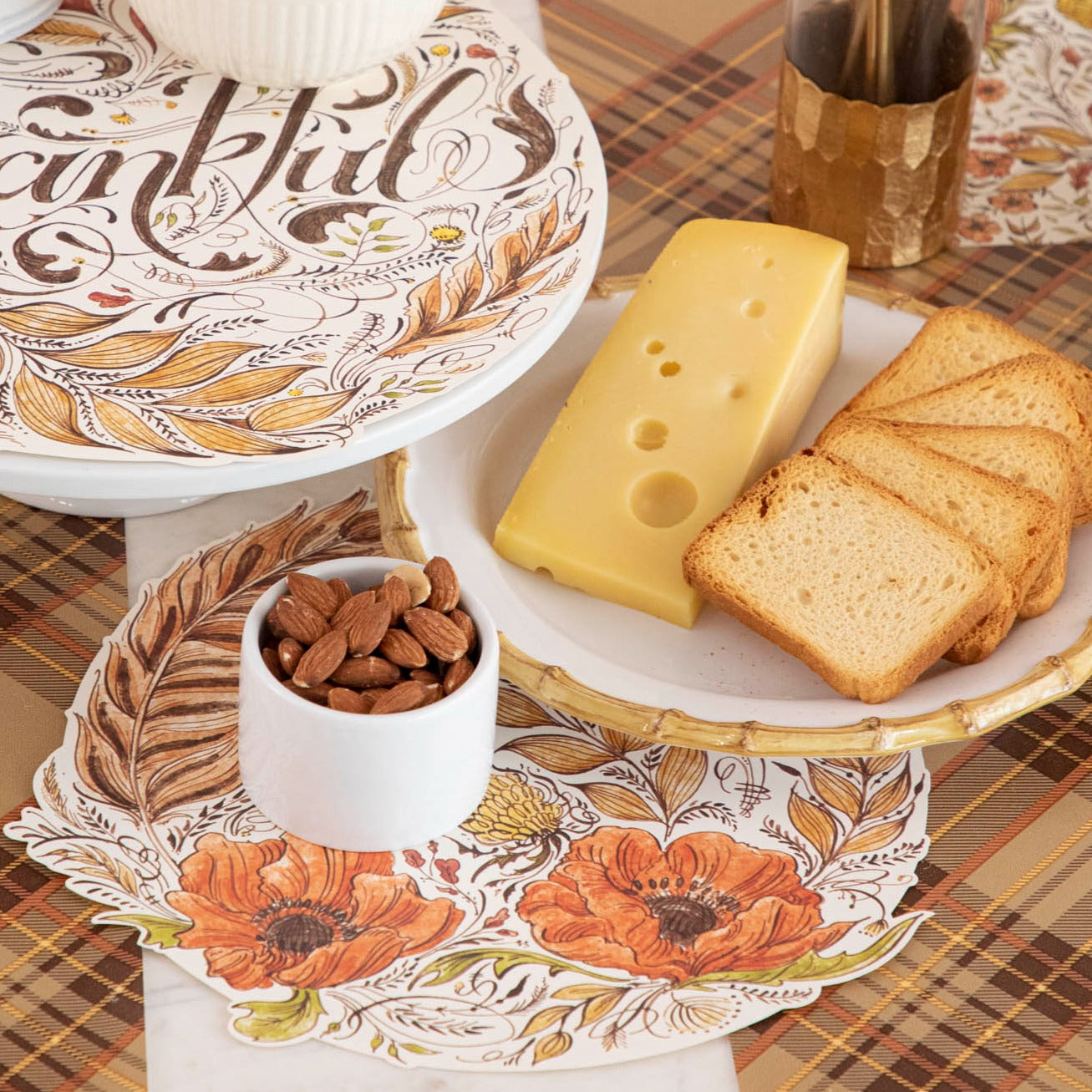 The Thankful Serving Papers on a fall themed table with cheese, crackers, nuts and flowers.