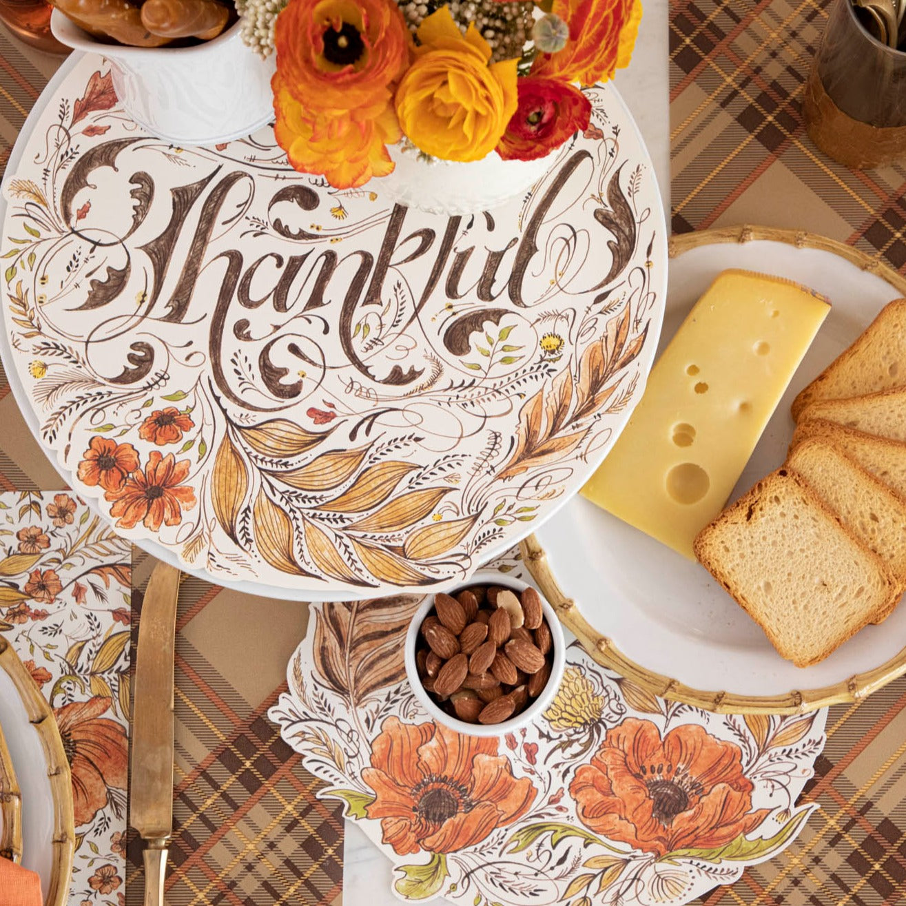 The Thankful Serving Papers on a fall themed table with cheese, crackers, nuts and flowers.