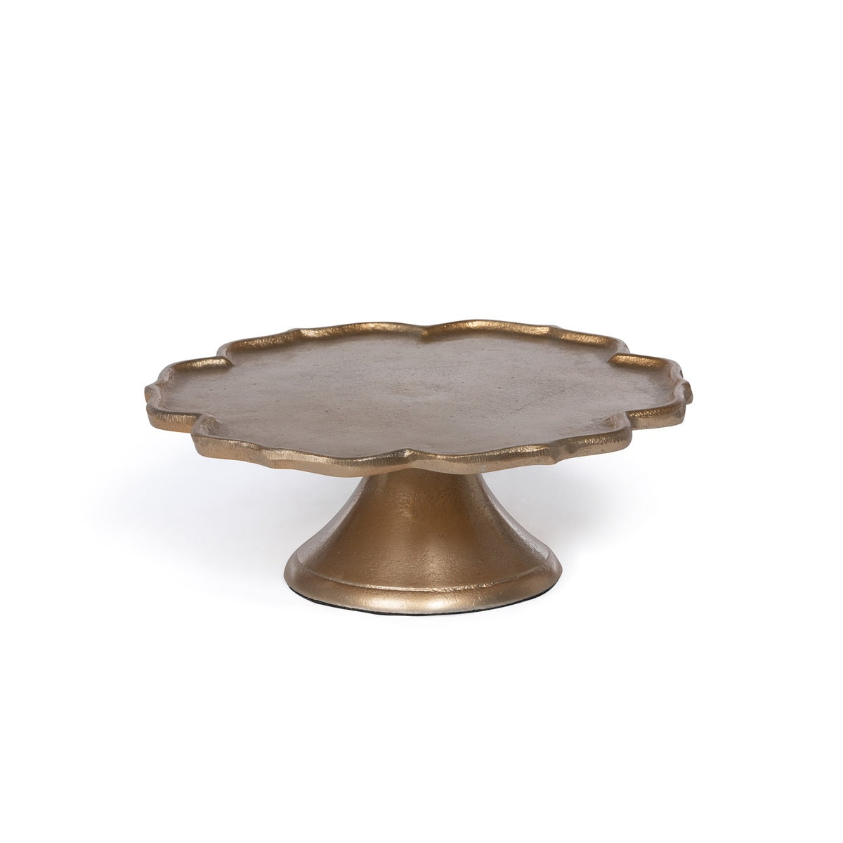 Decorative cake stand with scalloped edge and gold finish on a white background.