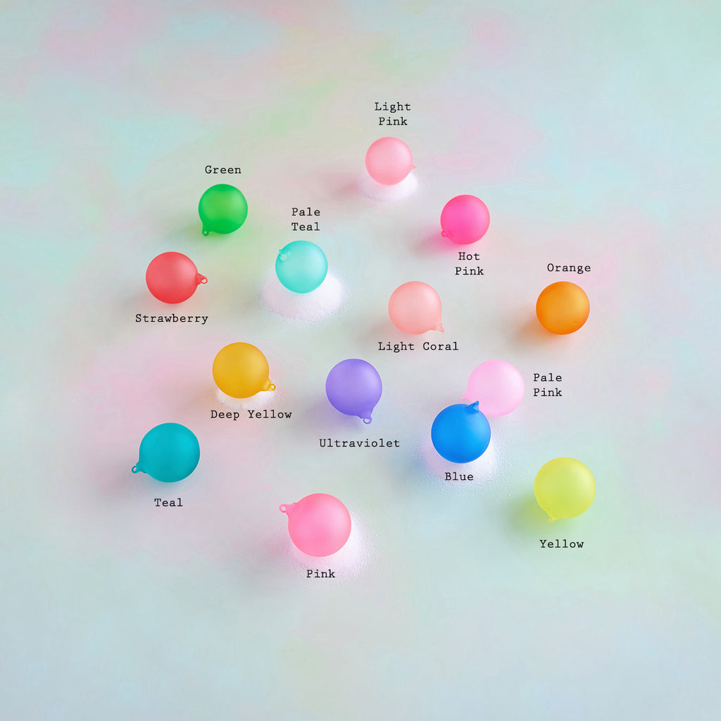 Color swatches of ball ornaments labeled with color names on a gradient background.