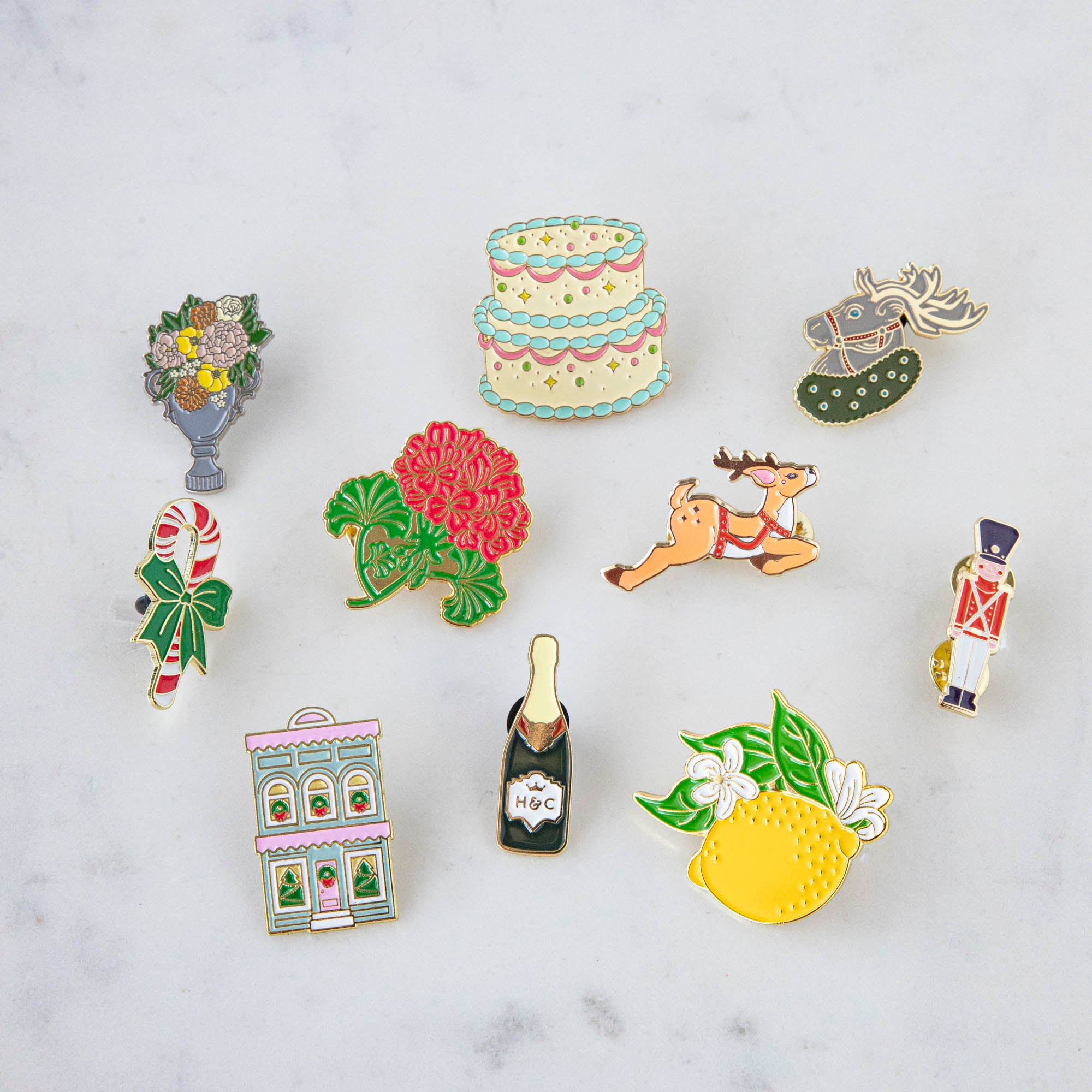 A set of Hester & Cook Lemon Enamel Pins featuring fresh fruits and a lemon design.