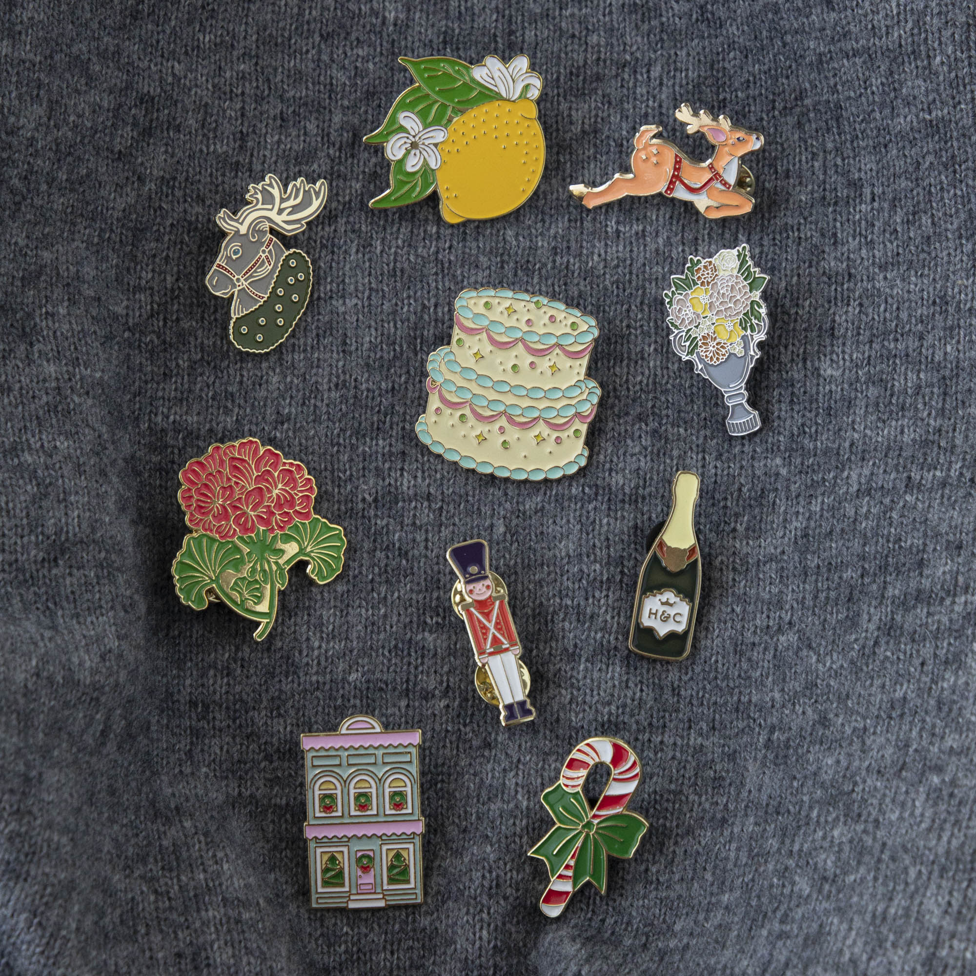 A vibrant collection of Hester & Cook Geranium Enamel Pins featuring charming geranium flowers.