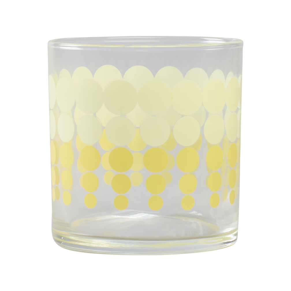 Clear glass candle holder with yellow polka dot pattern on a white background