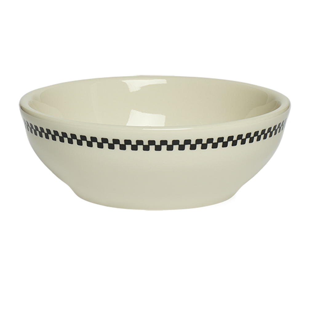 Beige ceramic bowl with black checkered pattern on a white background