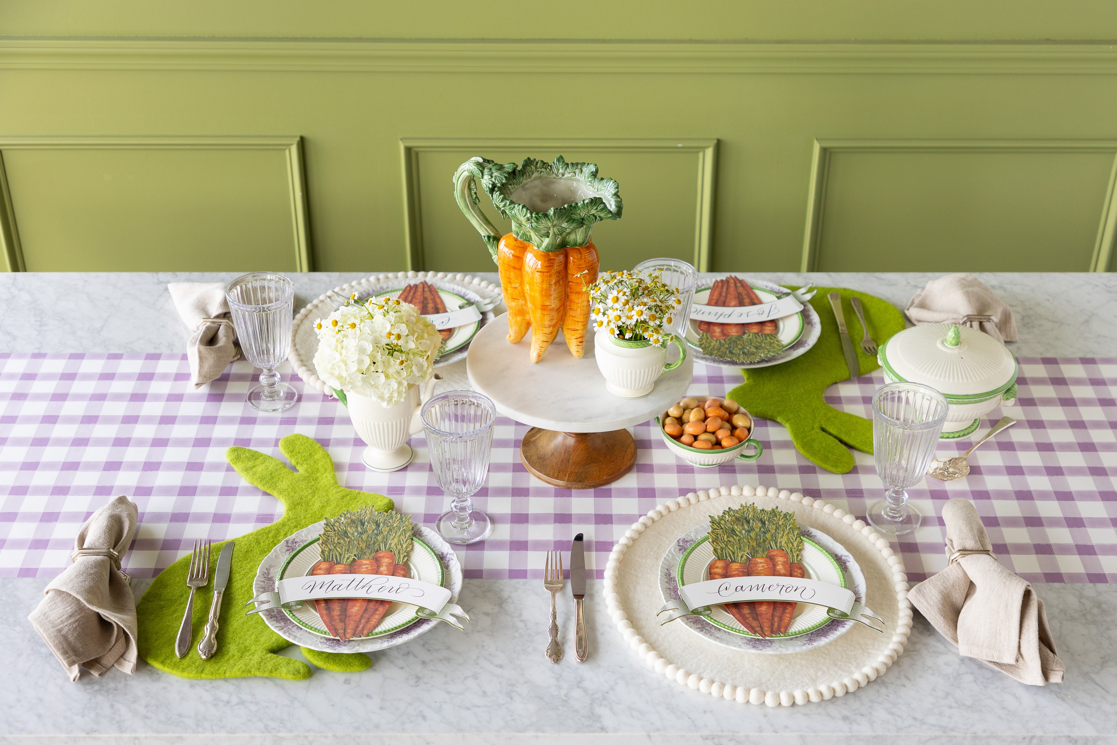 Easter-themed table setting with decorative plates, felt Spring Green Easter Bunny and Ivory Pom Pom Placemats, Carrots and Classic Moss Banner Table Accents.