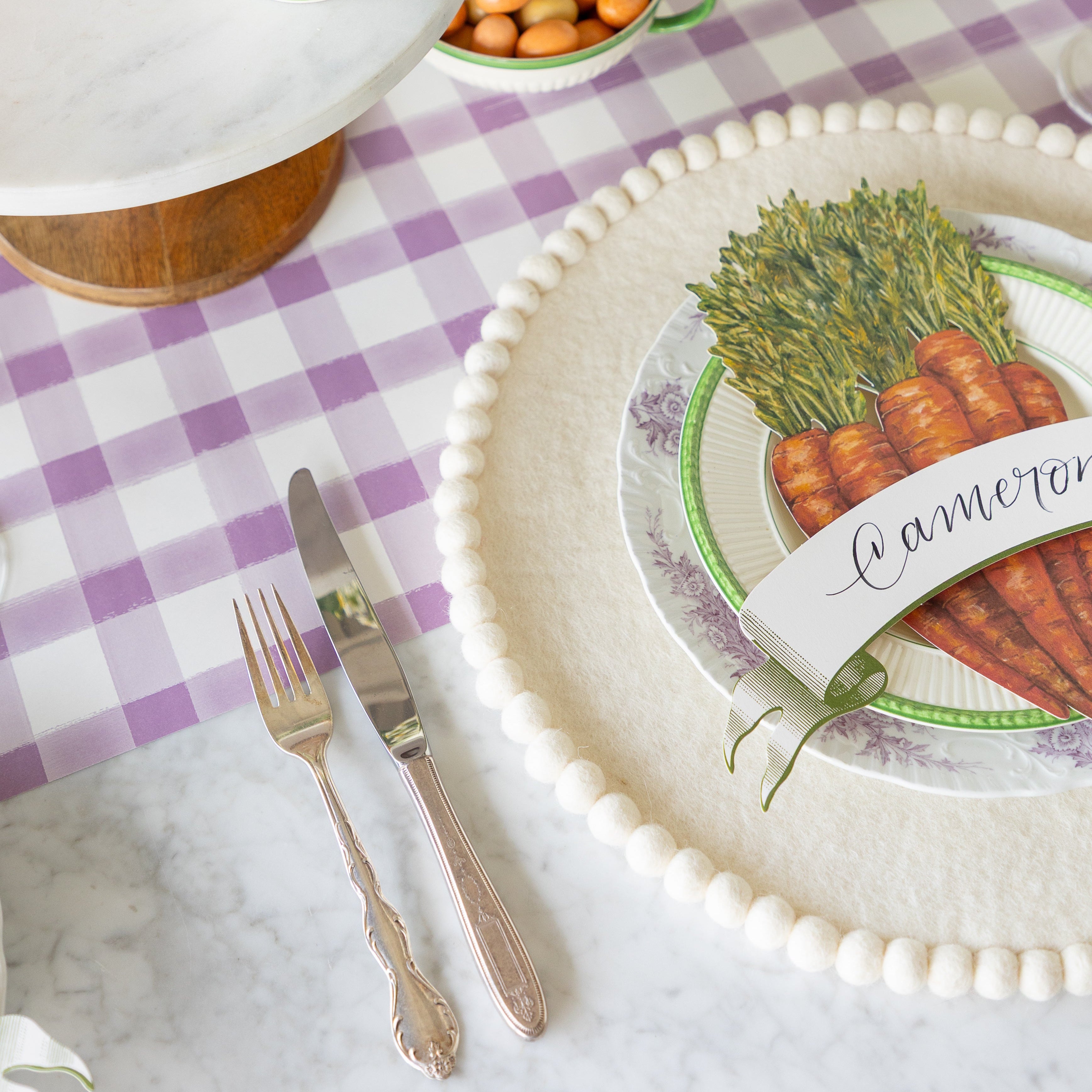 Spring-themed table setting with the Ivory Pom Felt Placemat on the Lilac Painted Check Runner.