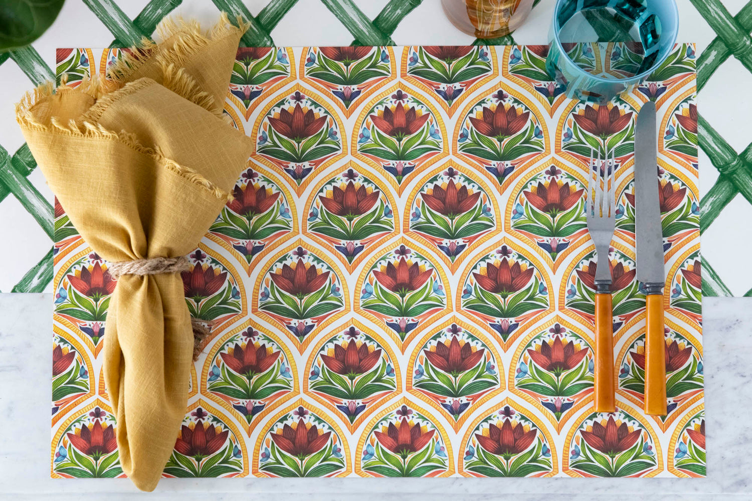 The Fiesta Floral Tile Placemat used in a festive place setting sans plate, from above.