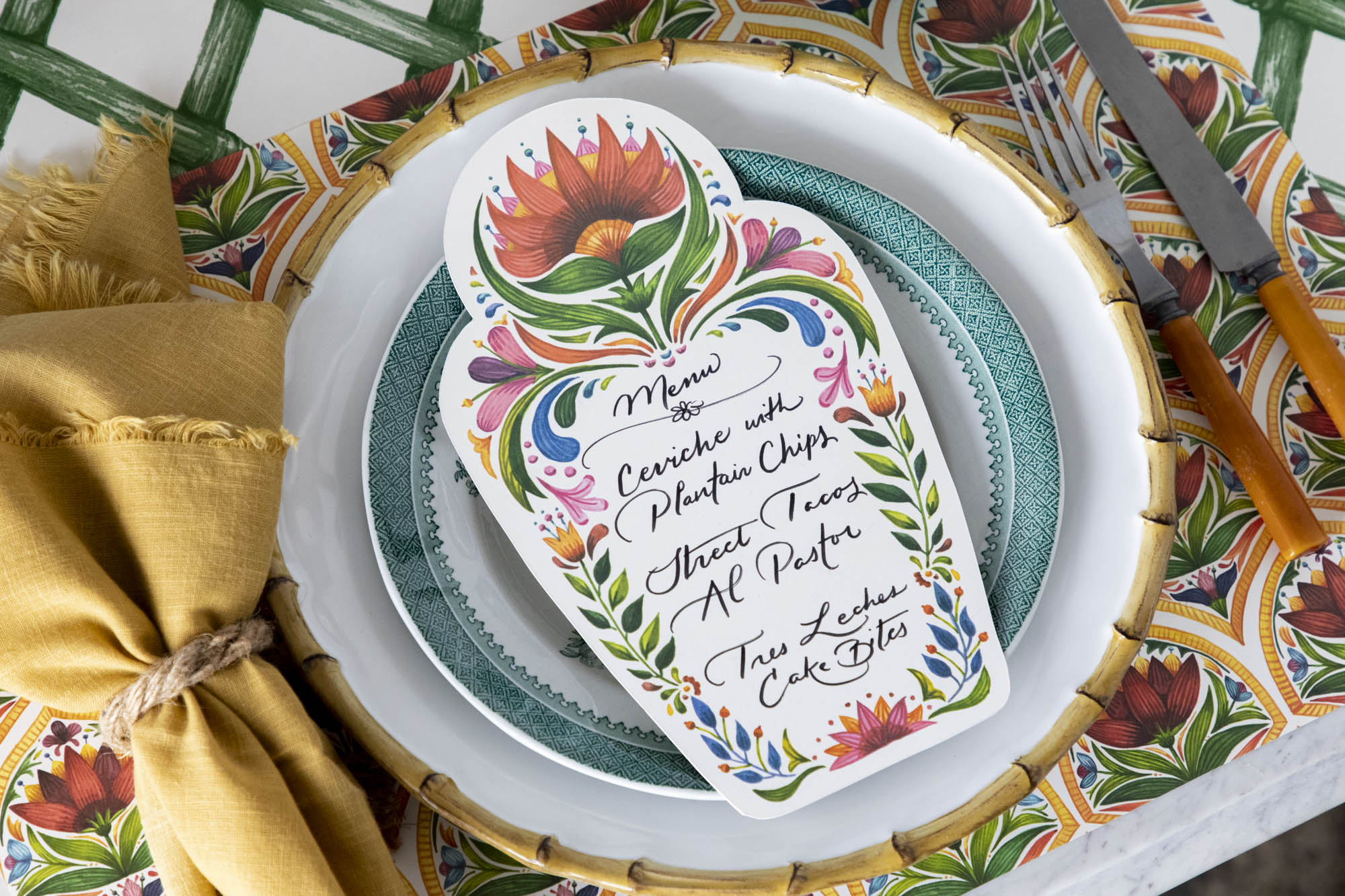 Close-up of a festive place-setting over the Fiesta Floral Tile Placemat.