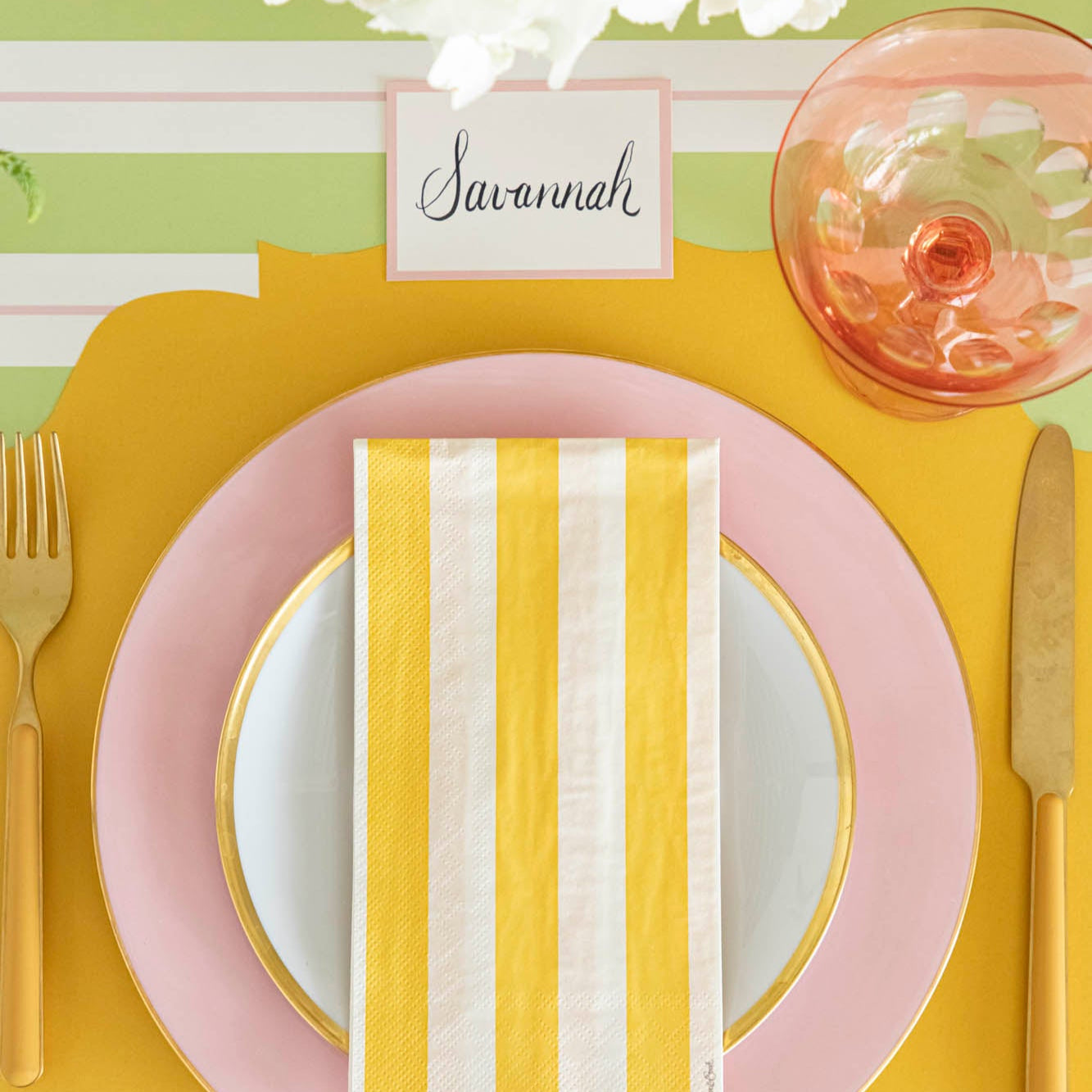 Pink Frame Place Card with "Savannah" written on it, behind a place setting for one.