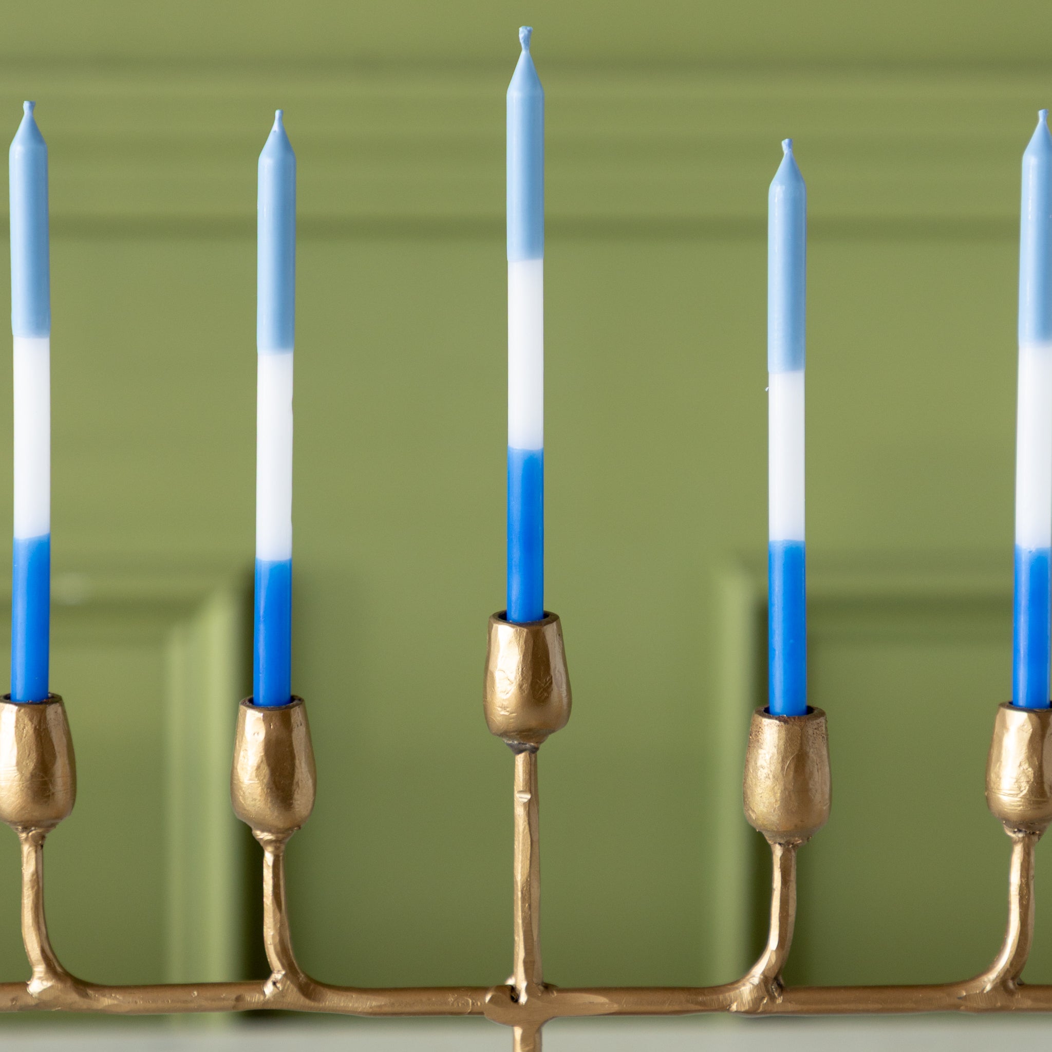 Gold menorah with blue and white menorah candles.