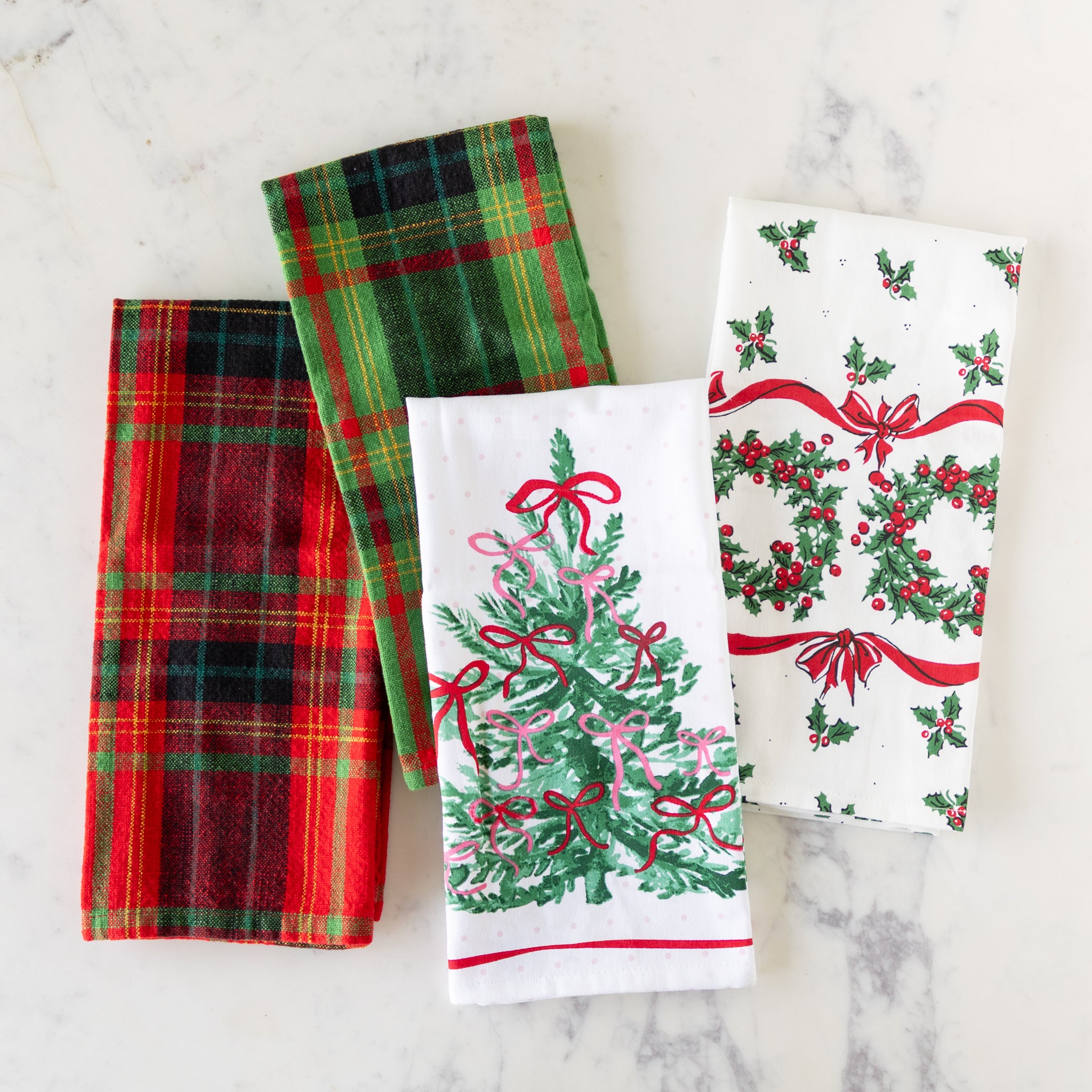Holiday tea towels on a marble table.