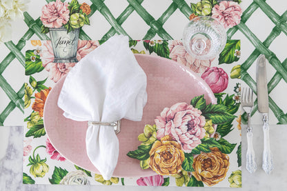 An elegant floral place setting with a Garden Derby Table Accent resting on the edge of the pink plate.