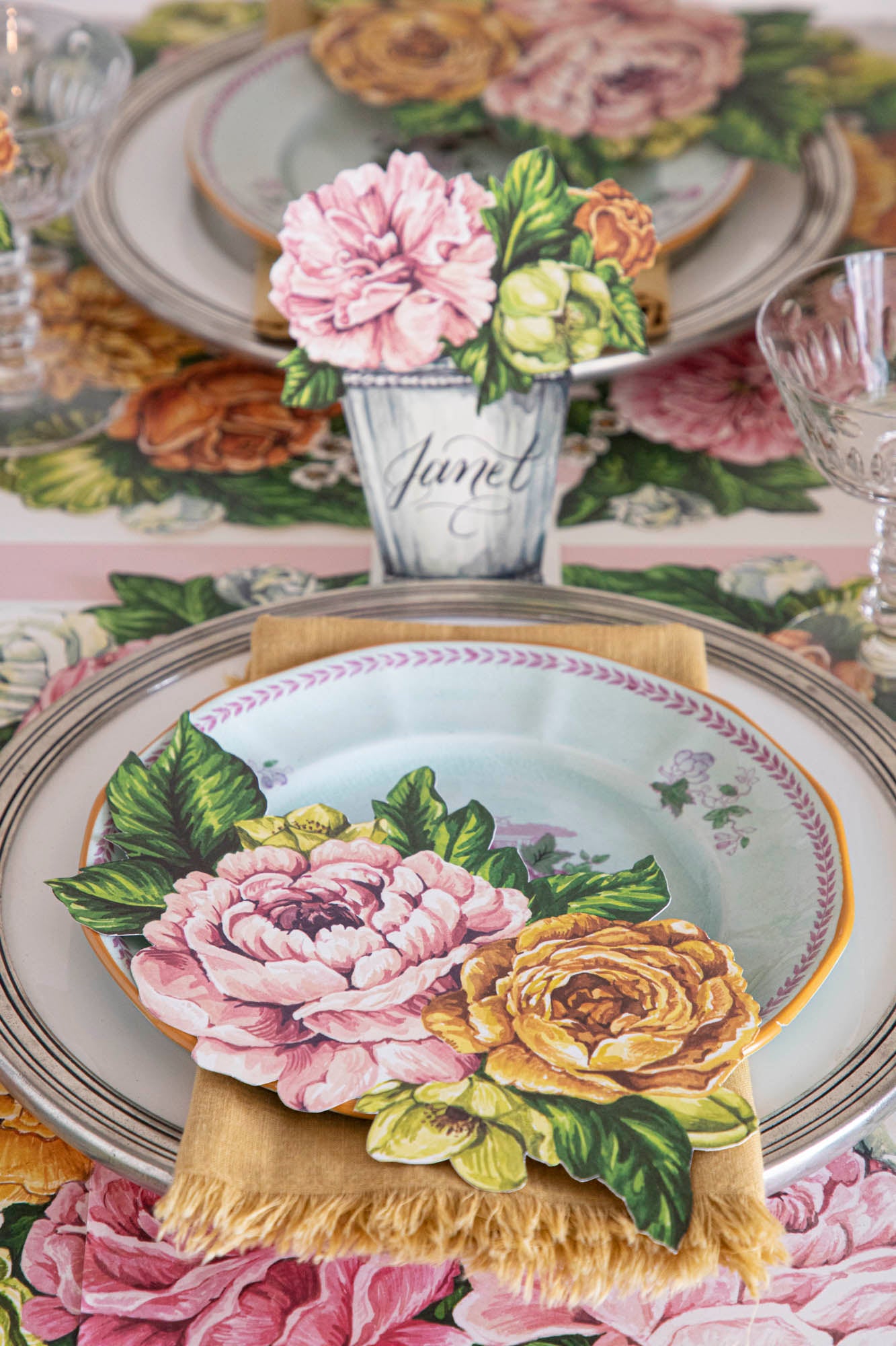 An elegant floral table setting featuring a Garden Derby Table Accent resting on each plate.