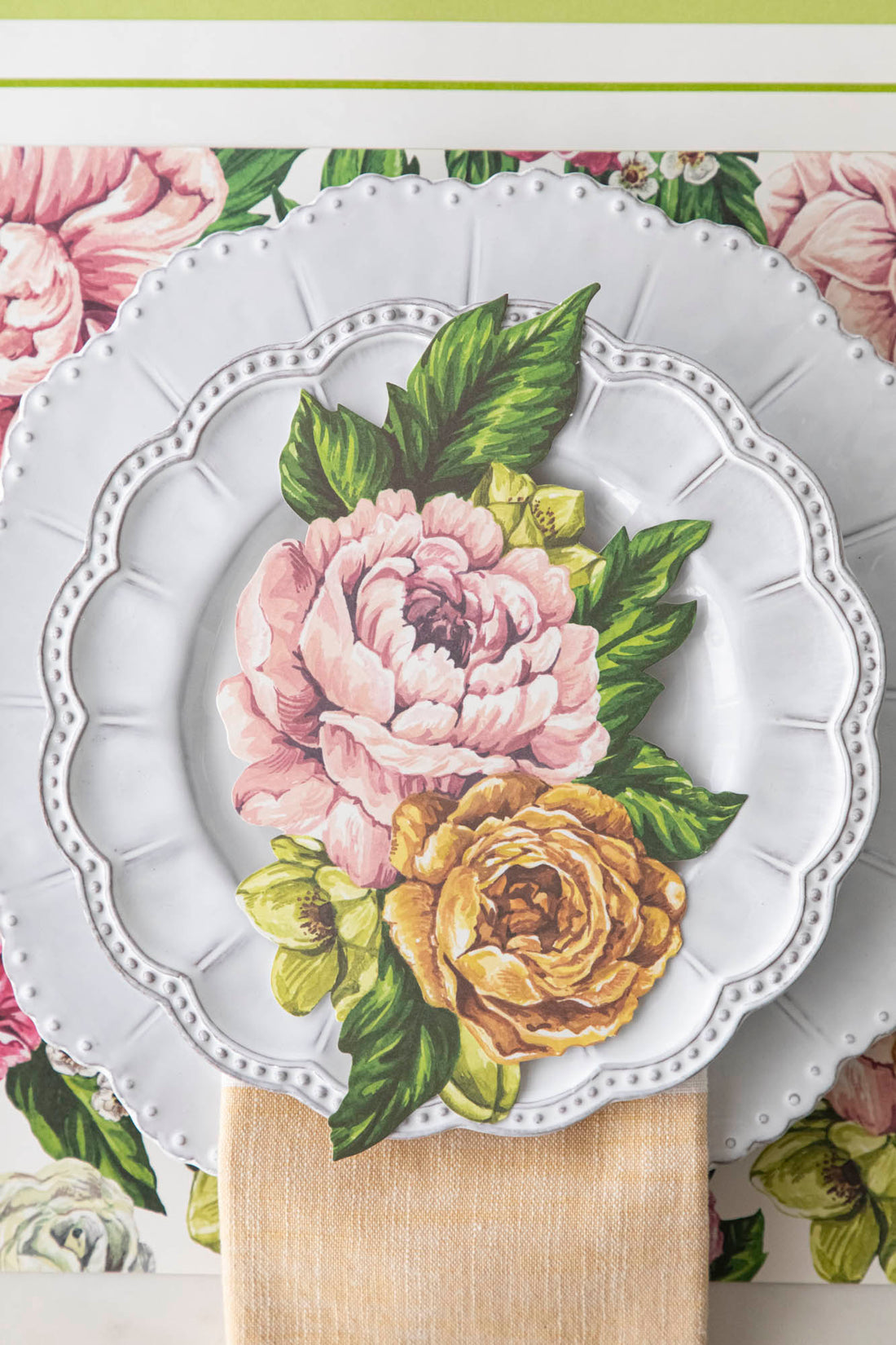 Top-down view of a floral place setting featuring a Garden Derby Table Accent resting on the plate.