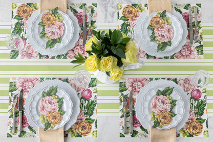 Top-down view of an elegant floral table setting for four, featuring a Garden Derby Table Accent resting on each plate.