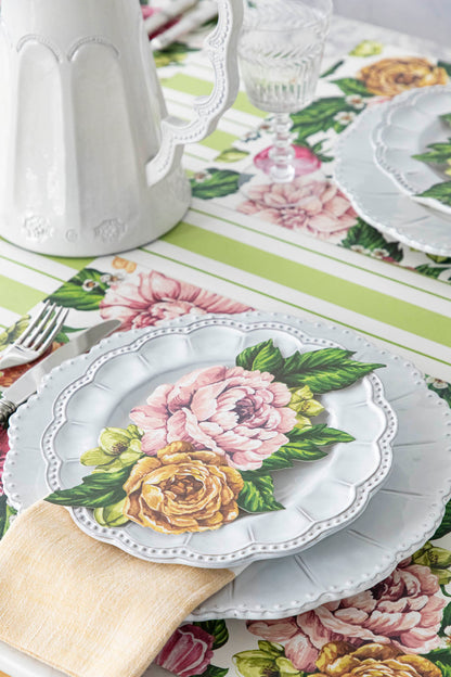 A Garden Derby Table Accent resting on the plate of an elegant floral place setting.