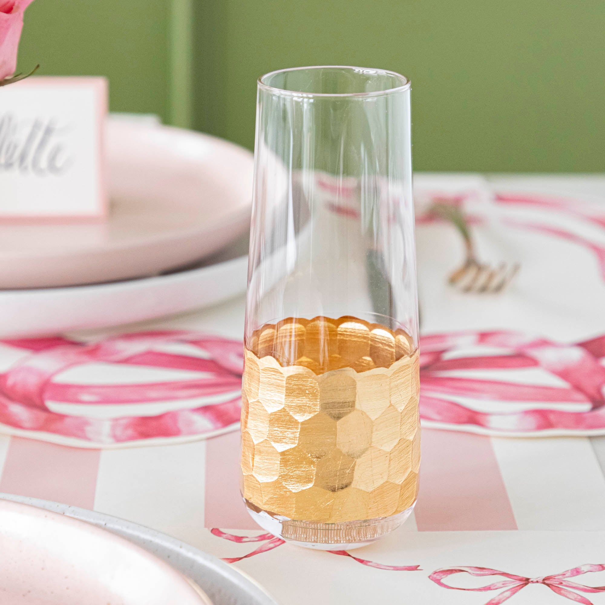 A table setting with Vitorrio Stemless Glassware plates, and napkins.