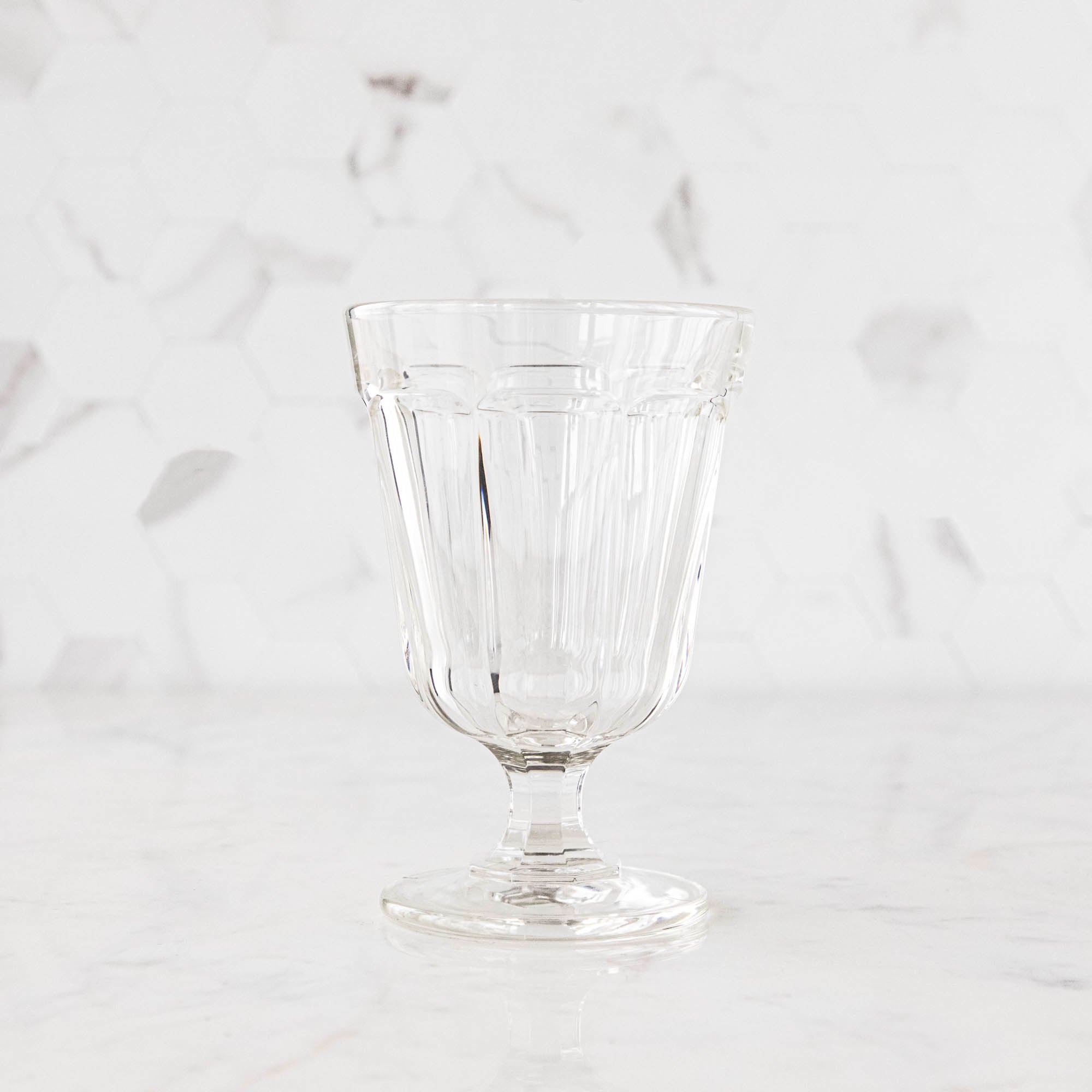 Two Casafina Living Gomos Water Glasses on a wooden table.