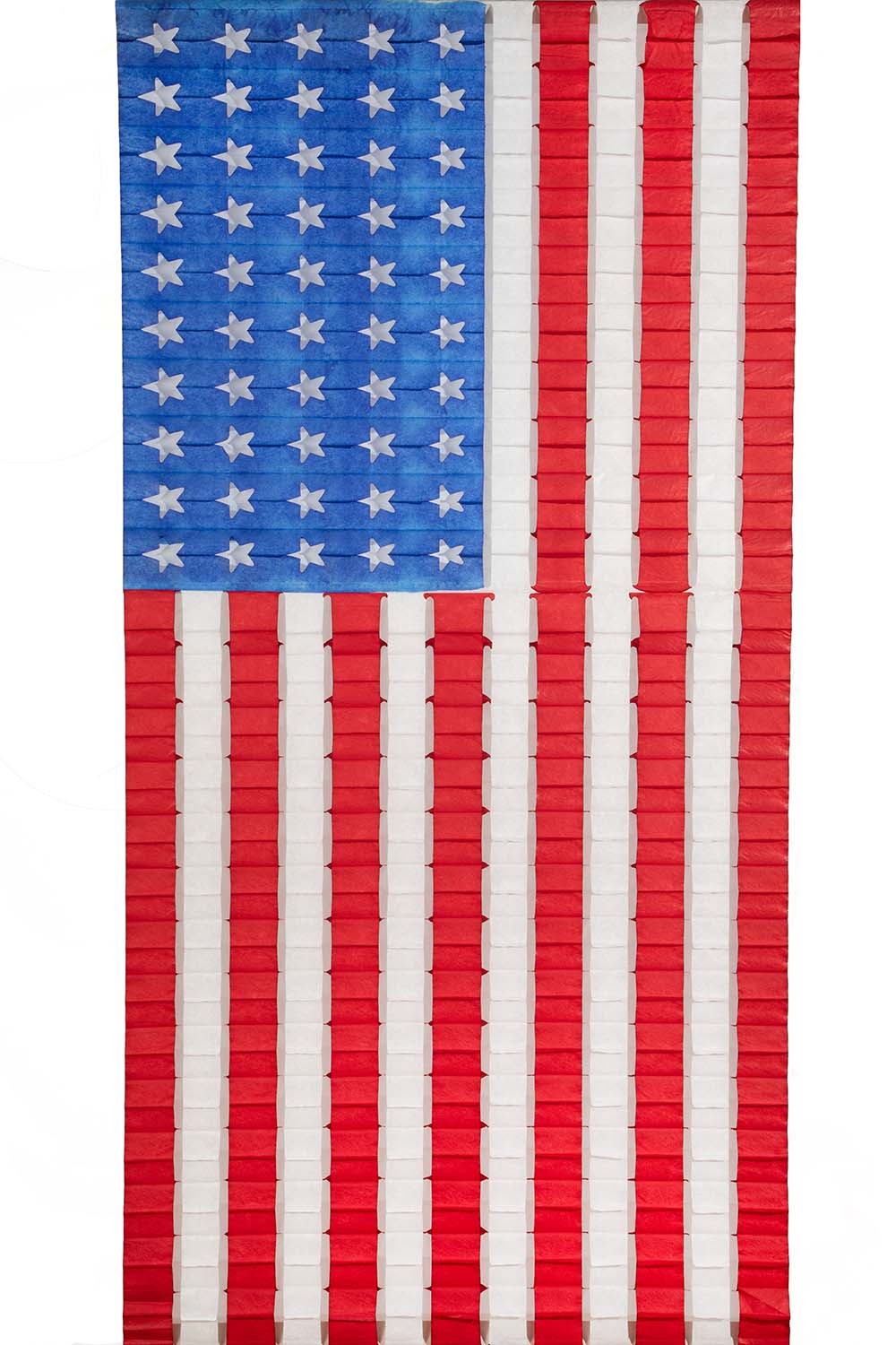 A large, decorative honeycomb paper flag with red and blue stripes and white stars, resembling the American flag.