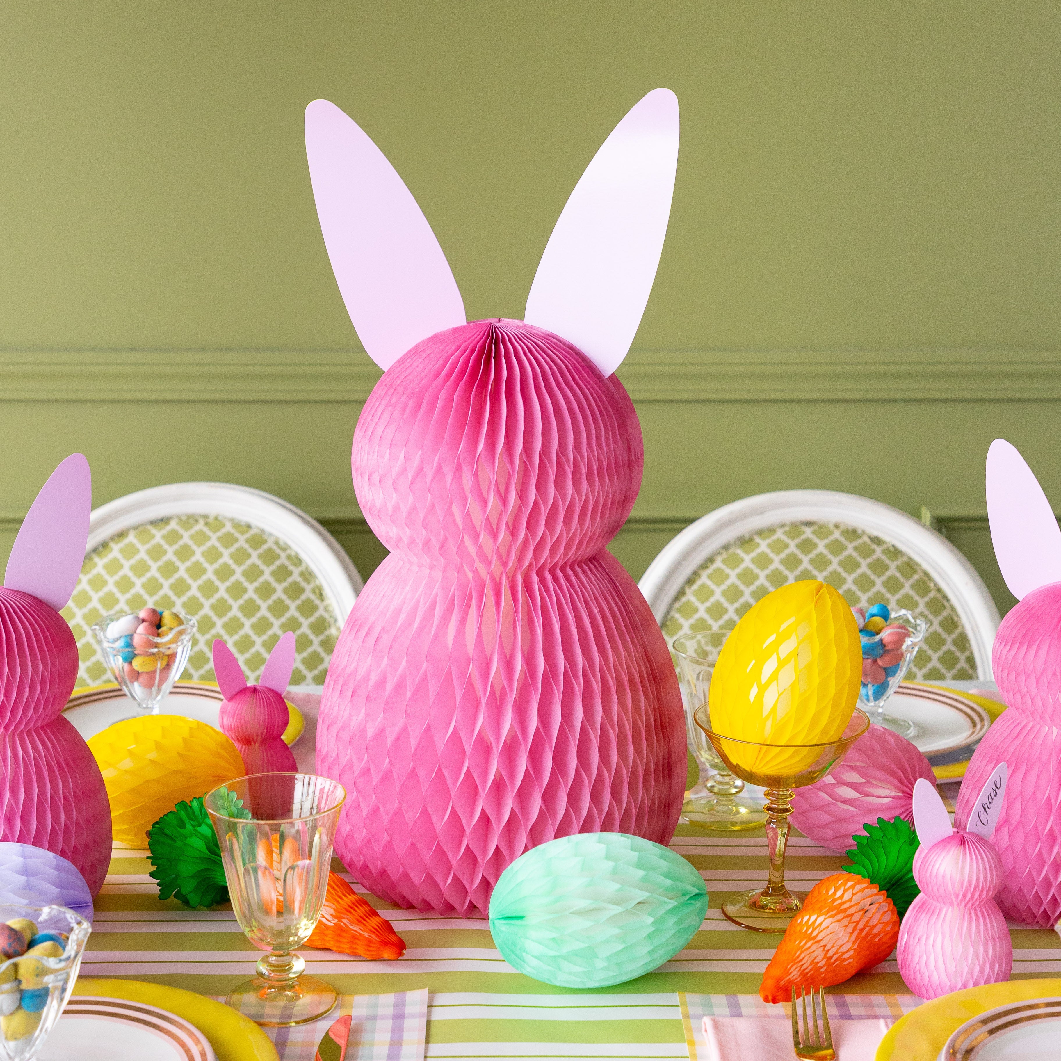 Colorful Easter table setting with bunny decorations and pastel colors.