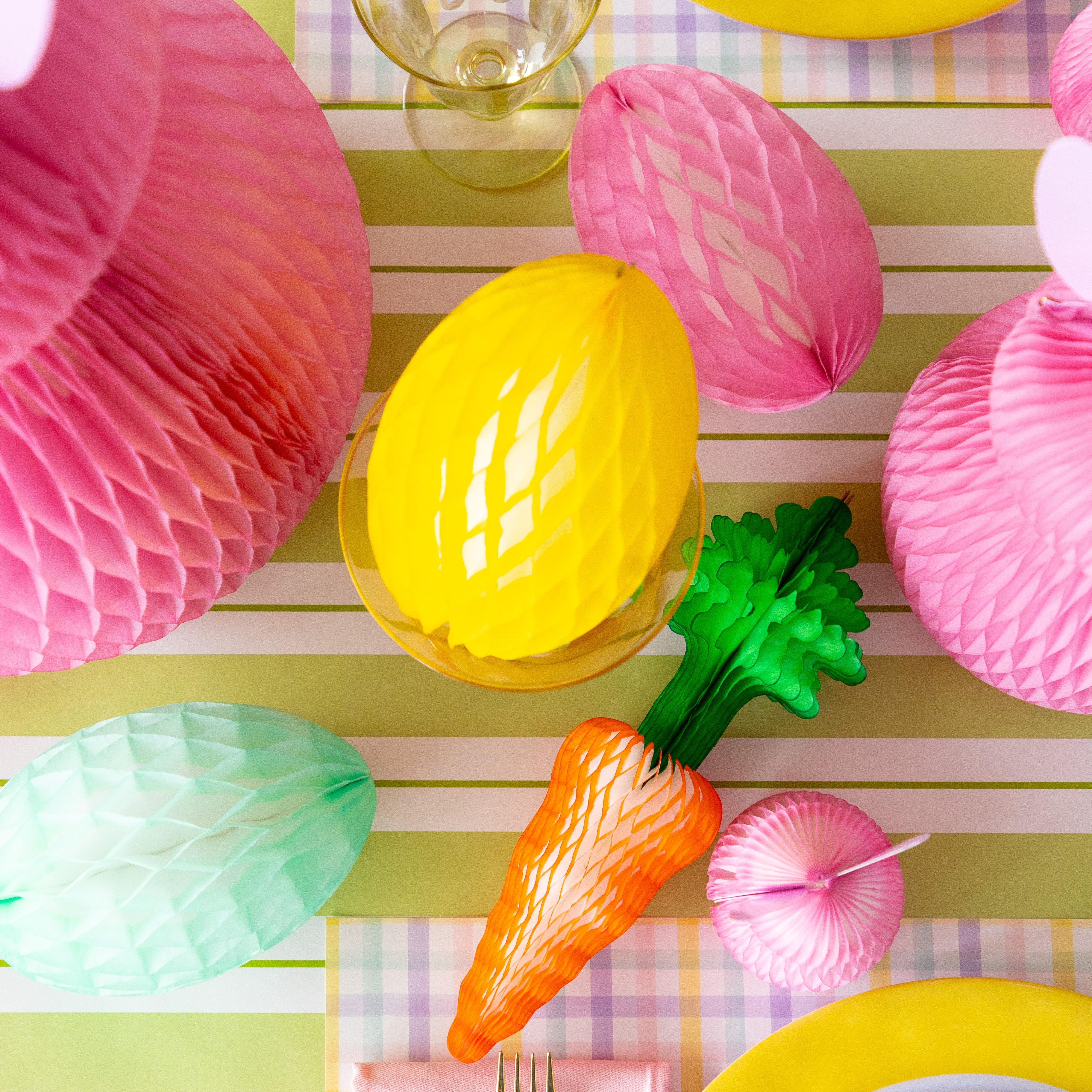 Colorful Easter table setting with Honeycomb Easter Eggs, bunnies and carrots.