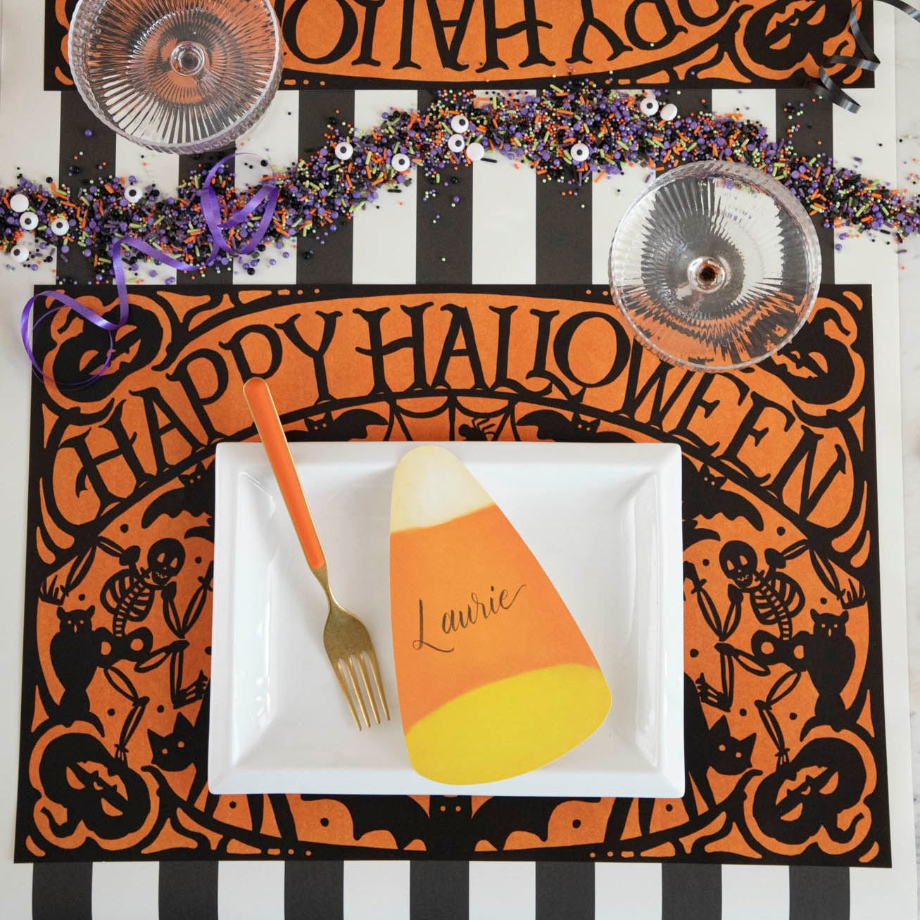 Wicked Halloween Placemat table set up with dinnerware and halloween themed sprinkles
