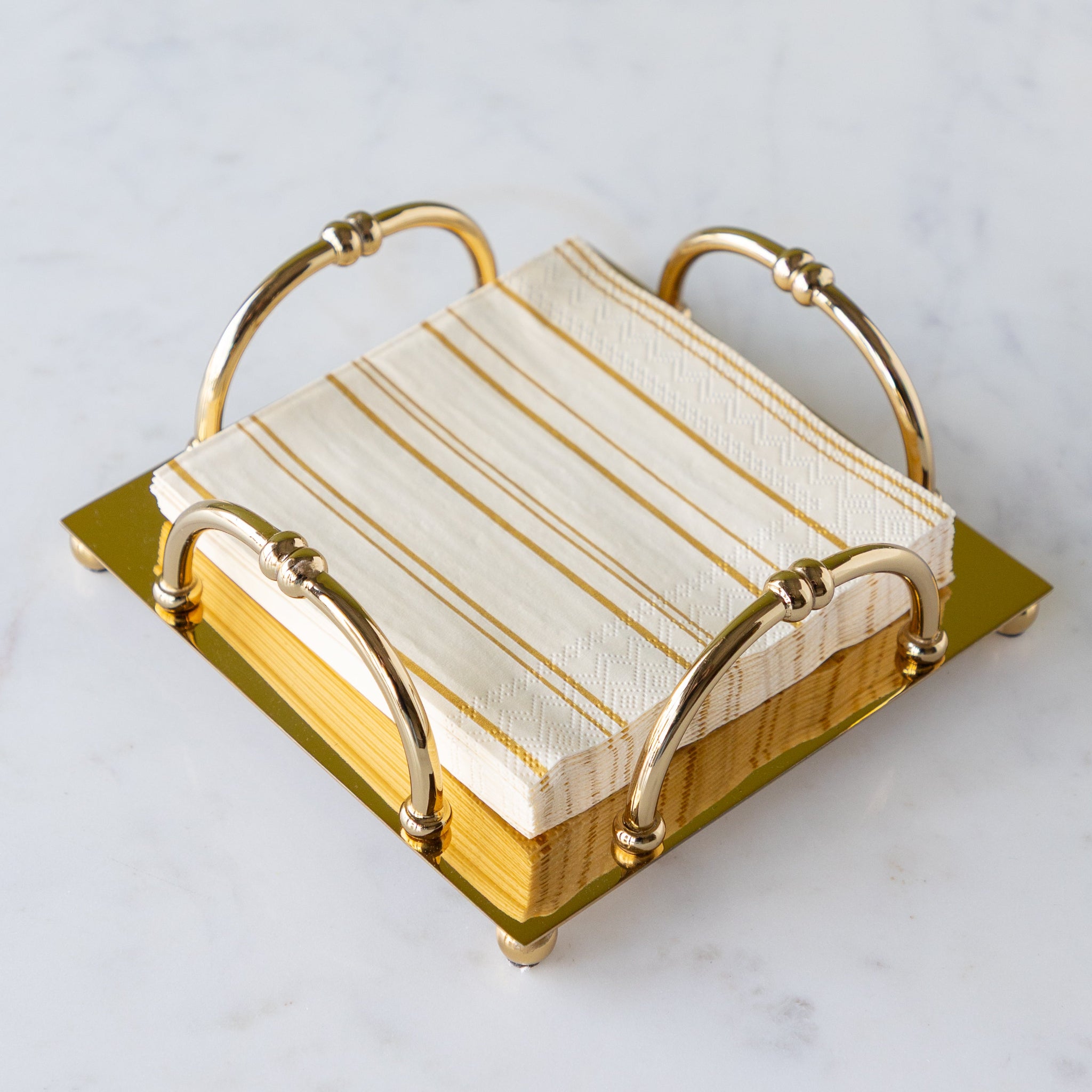 Gold Scalloped Napkin Holder in the cocktail size with Antique Gold Stripe Cocktail Napkins in them.
