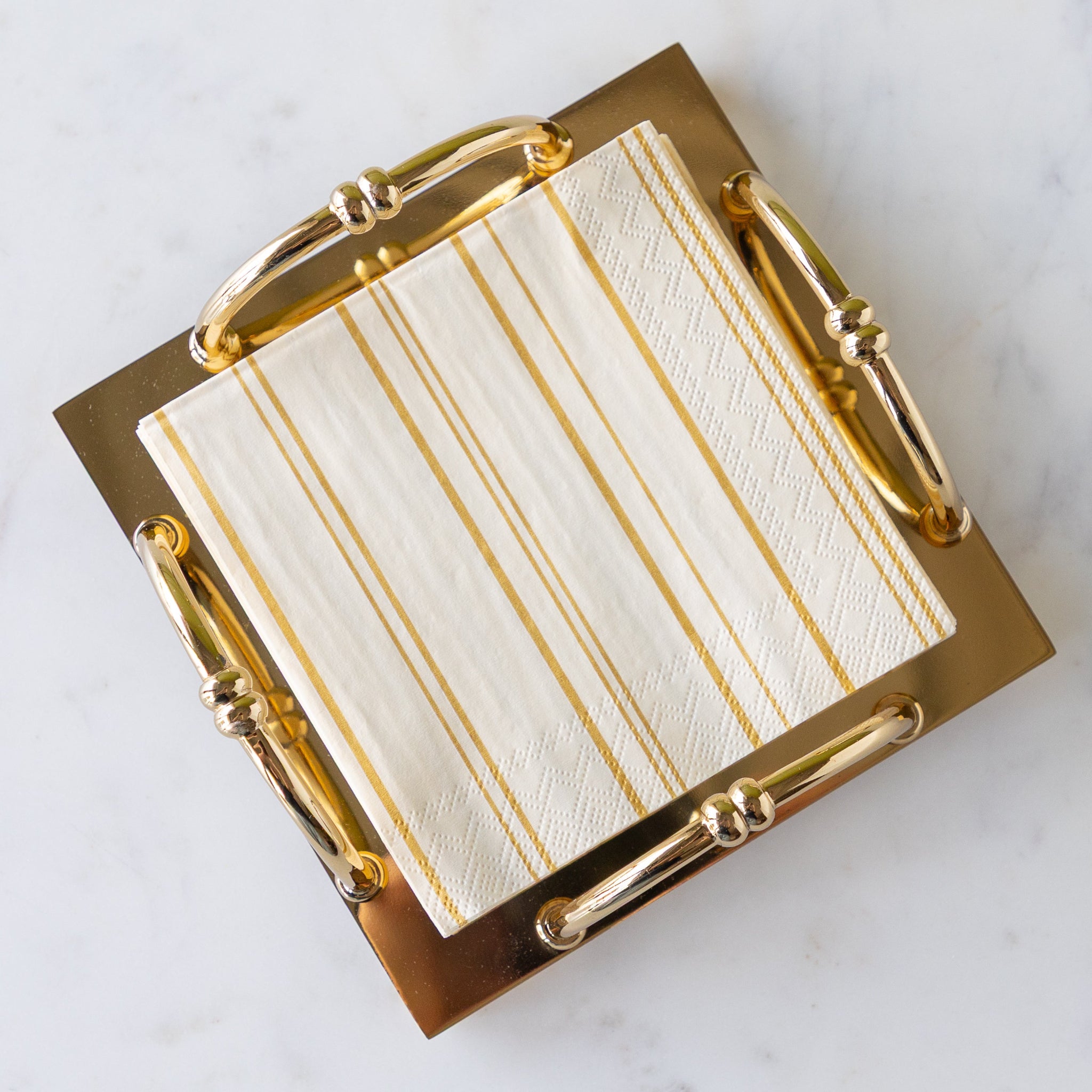 Gold Scalloped Napkin Holder in the cocktail size with Antique Gold Stripe Cocktail Napkins in them.