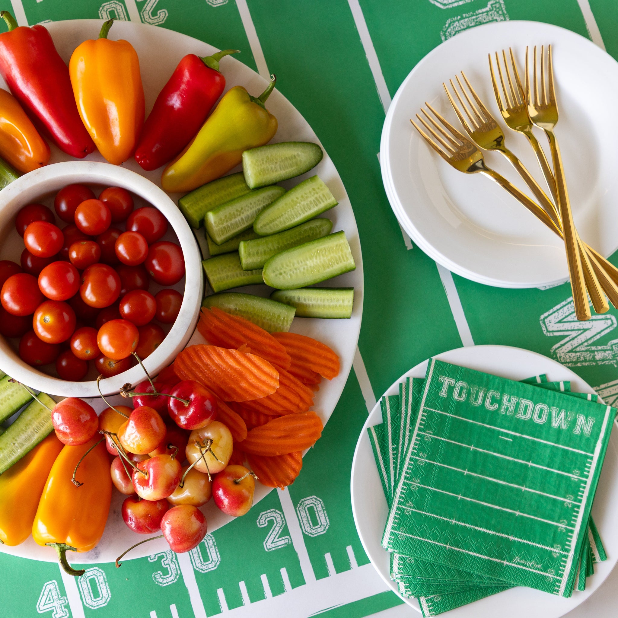 Marble Chip and Dip Server with fruits and veggies atop, Touchdown Cocktail Napkins and plates and forks on the Touchdown Runner.