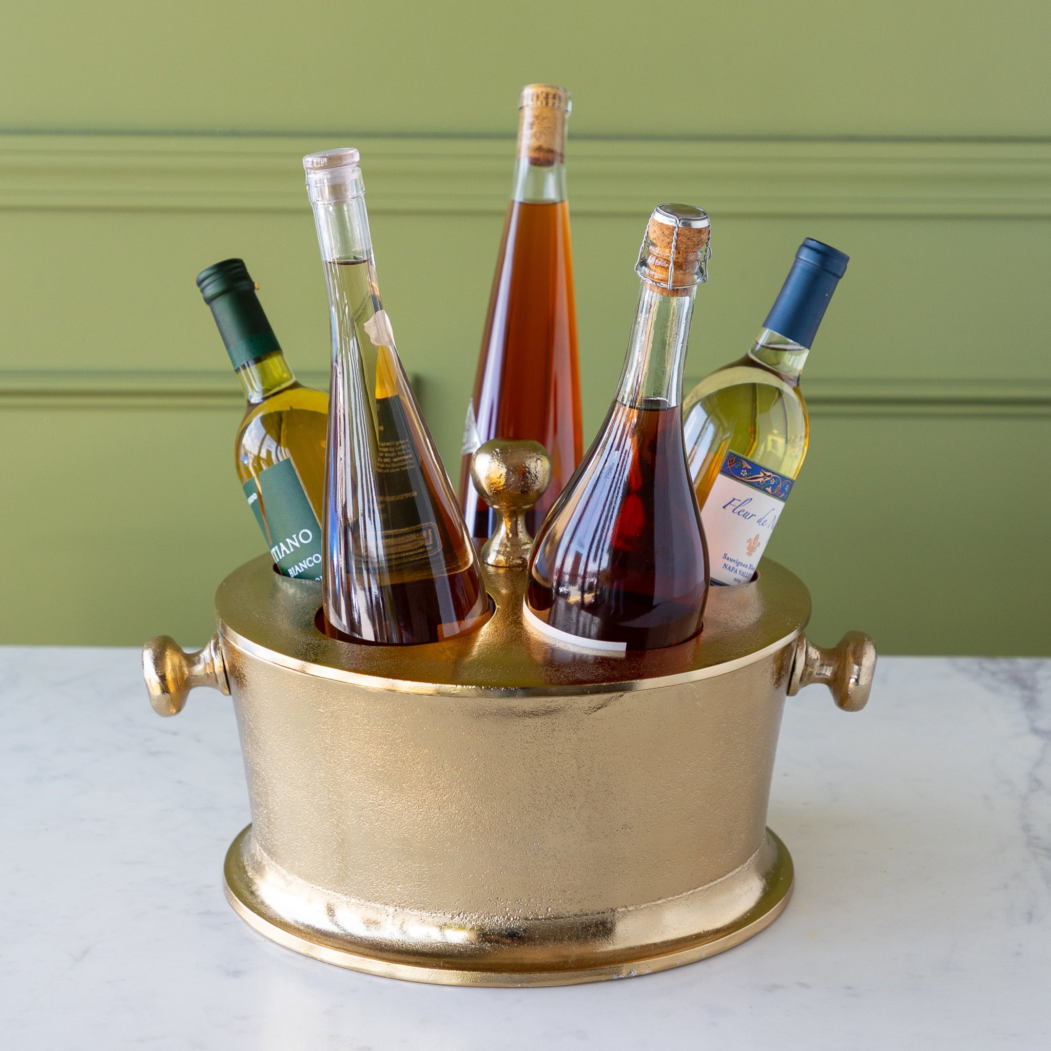 Gold Raw Aluminum Bottle Holder filled with 5 wine bottles.