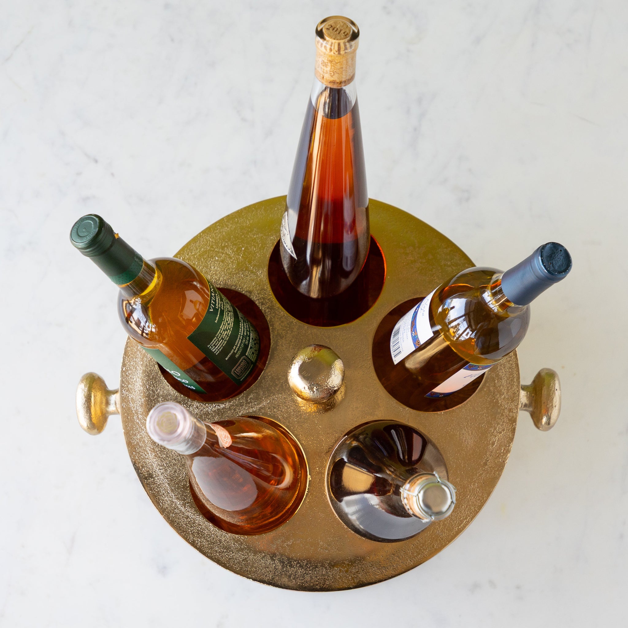 Gold Raw Aluminum Bottle Holder with 5 wine bottles, a knob in the center and on both sides of the bucket.