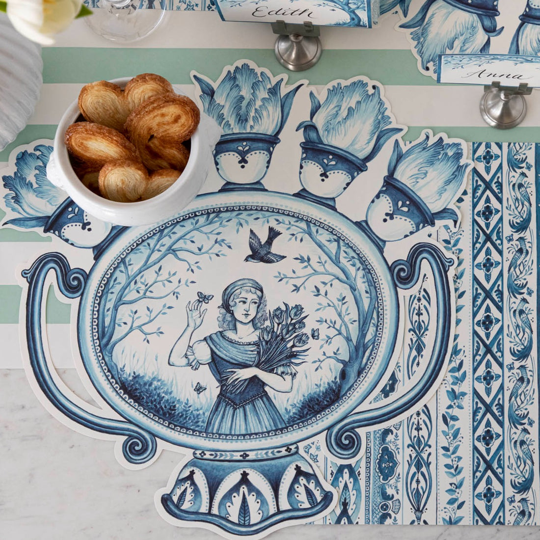 The Die-cut Indigo Meadow Placemat under an elegant place setting sans plate, from above.