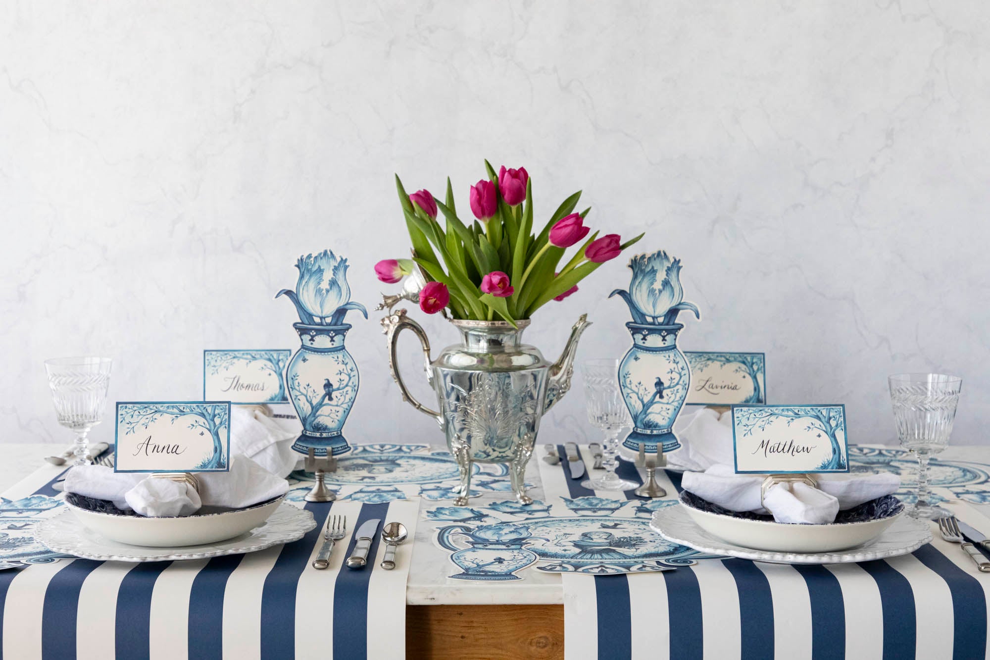 A serene Indigo Meadow place card on a table with buffet labels, flowers, and plates that make guests feel extra special by Hester & Cook.