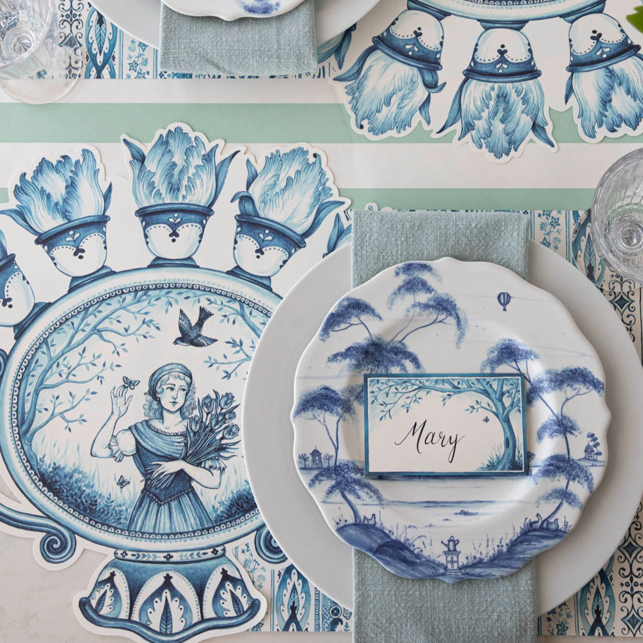 The Die-cut Indigo Meadow Placemat under an elegant table setting, from above.
