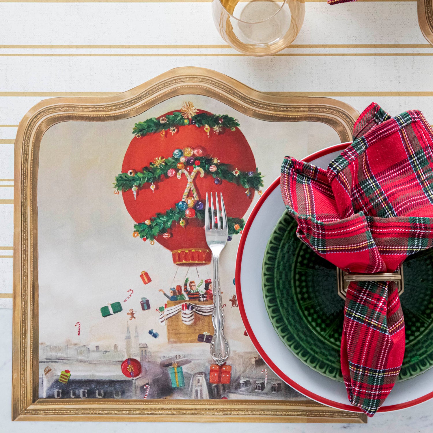 The Die-cut Christmas Balloon Ride Placemat under a festive Christmas-themed place setting, from above.