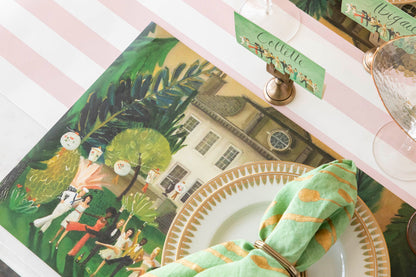 Close-up of the left side of the High Kick Placemat with a plate covering the other side, showing the vibrant artwork of a vintage party.
