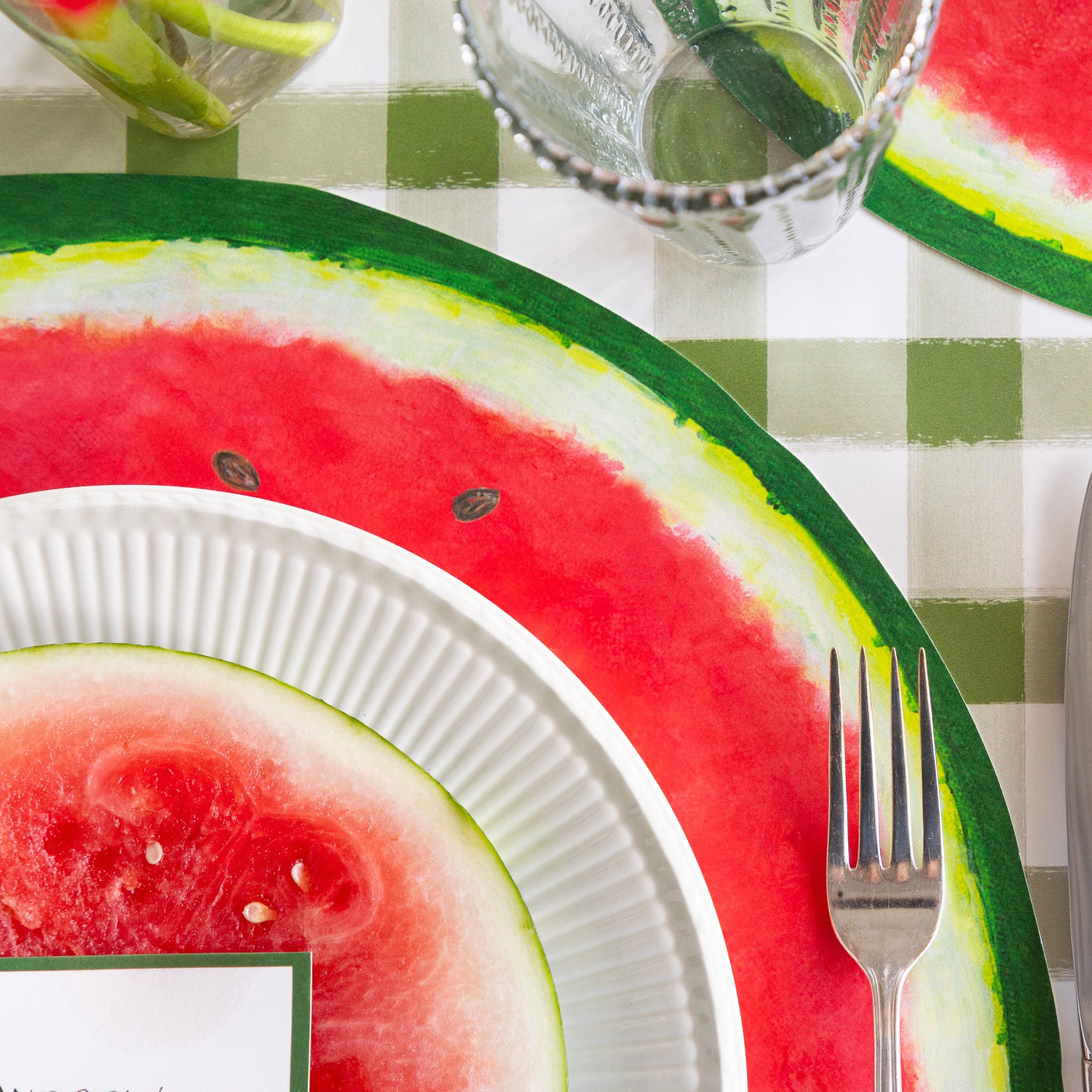 Place setting with Die-cut Watermelon Placemat on the Moss Green Painted Check Runner.