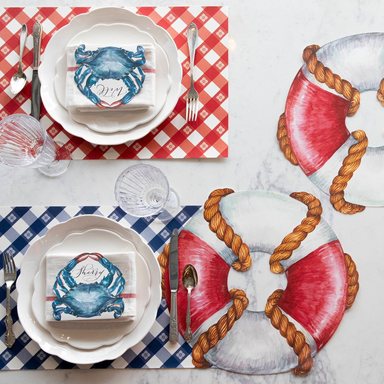The red and blue Picnic Check Placemats under a nautical-themed table setting for two, from above.