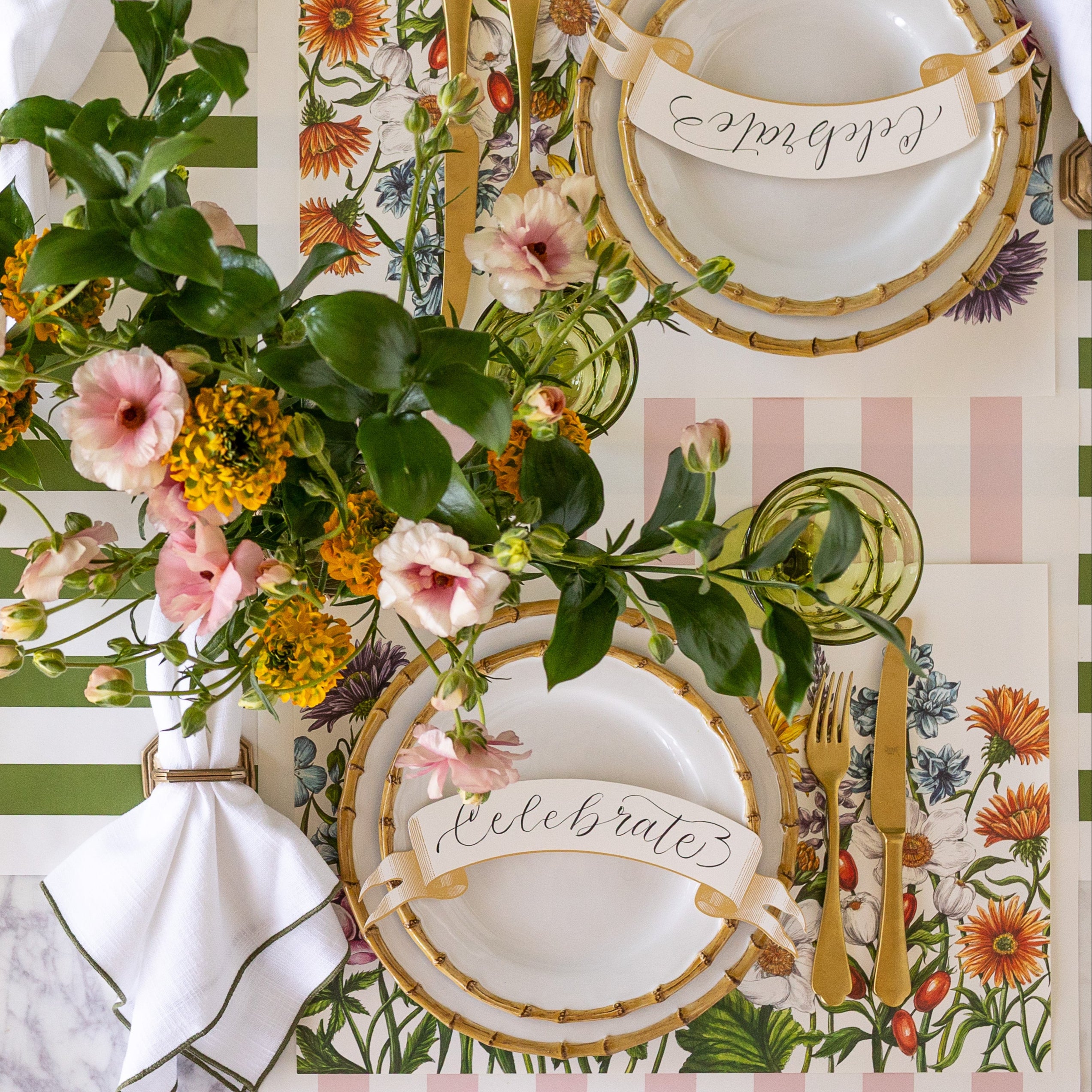 A spring table setting with wildflowers and the Wildflower Meadow Placemat under an elegant place setting.
