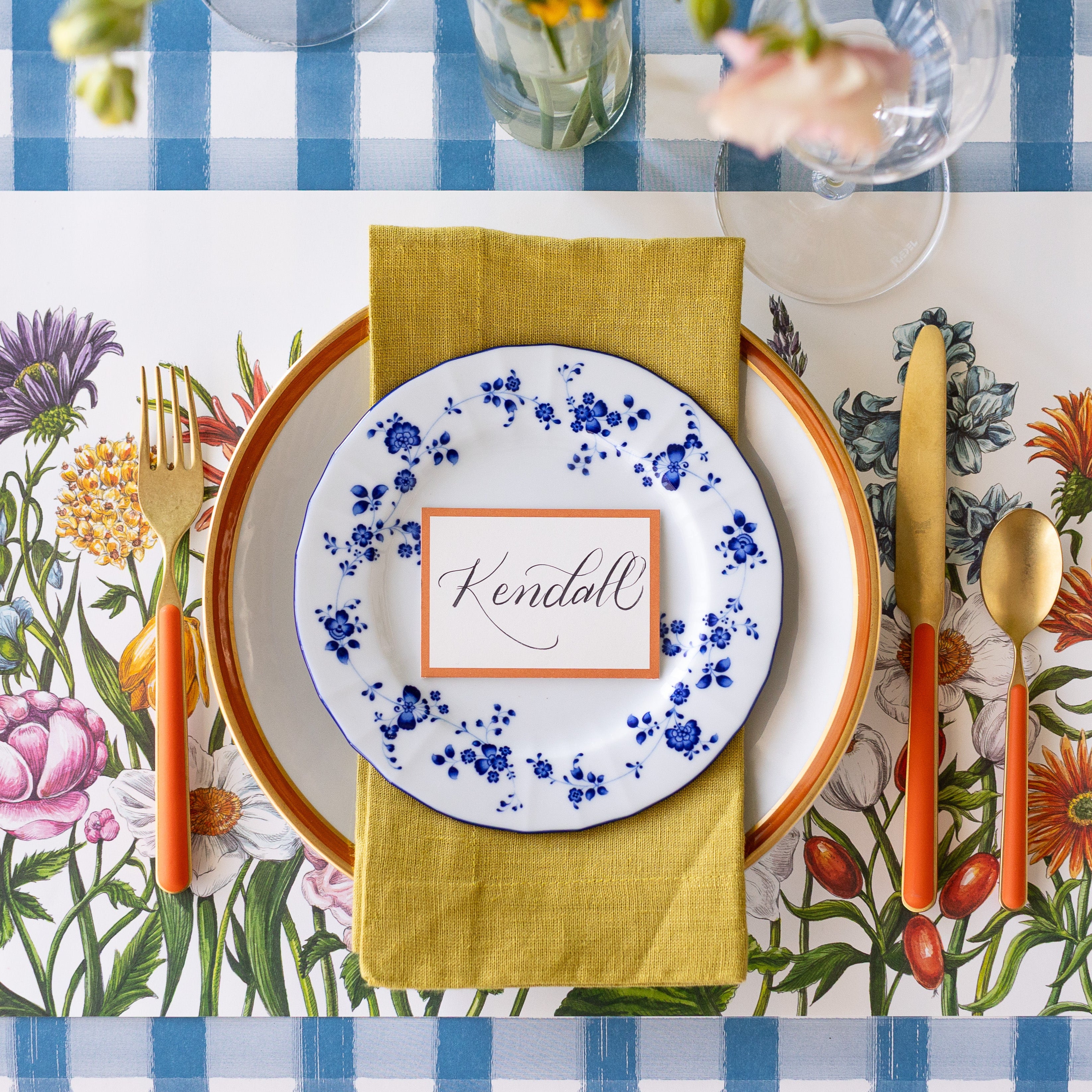 A spring place setting with the Wildflower Meadow Placemat on the Blue Painted Check Runner.