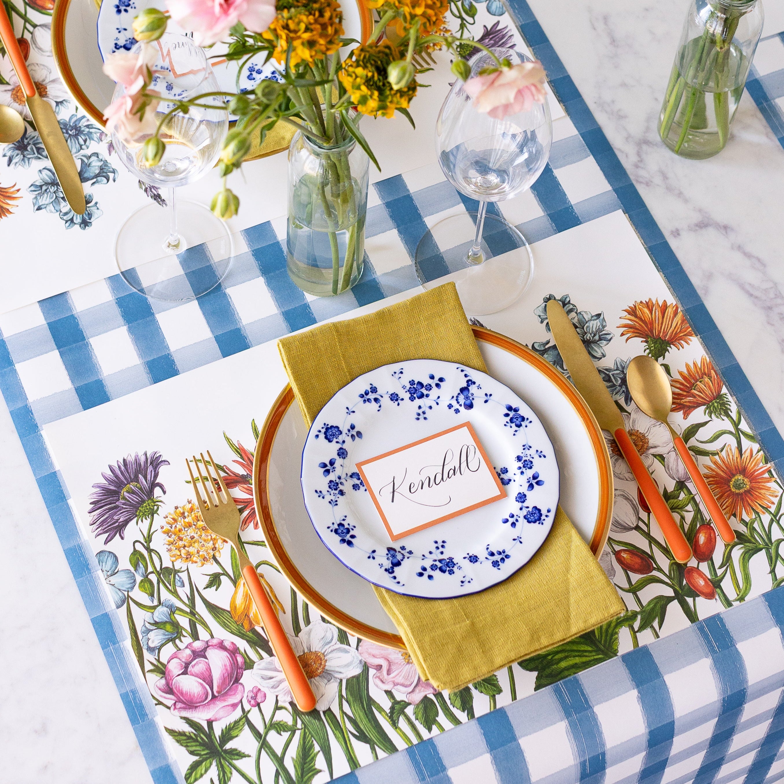 An elegant place setting with the Wildflower Meadow Placemat on the Blue Painted Check Runner.