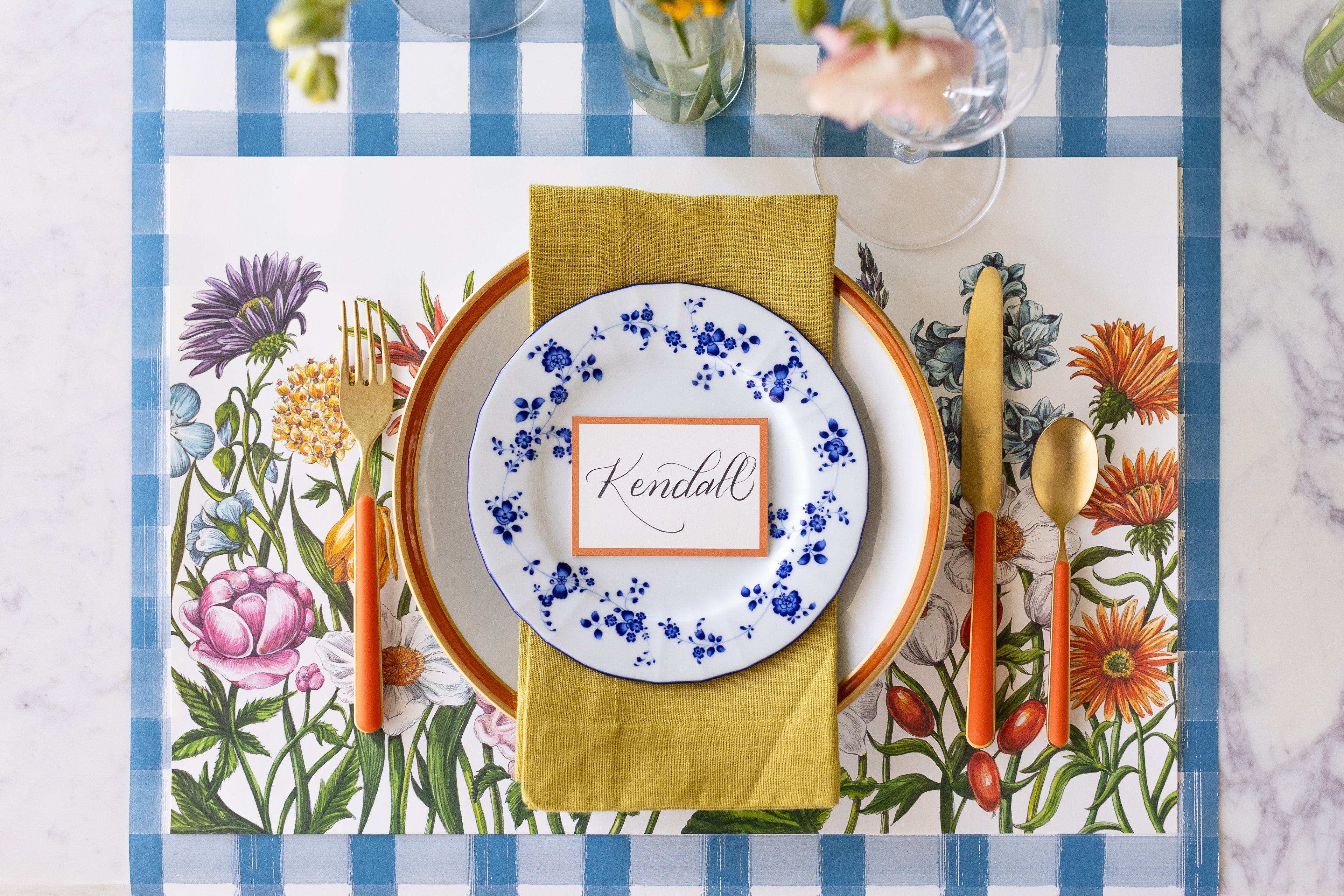 Our new Wildflower Meadow Placemat on our Blue Painted Check Runner styled with colorful dinnerware.