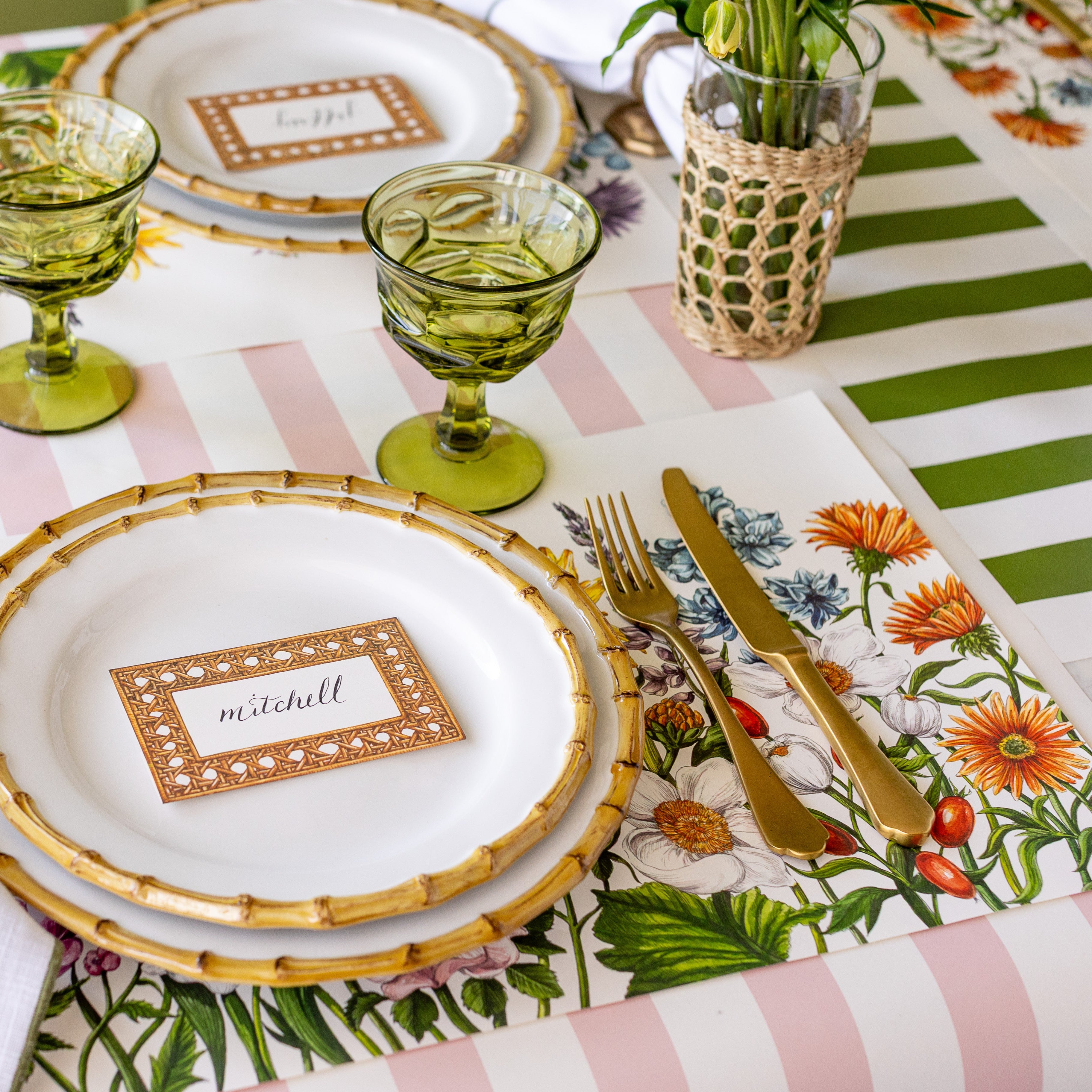 A spring place setting with the Wildflower Meadow Placemat paired with the pink and green classic stripe runners.