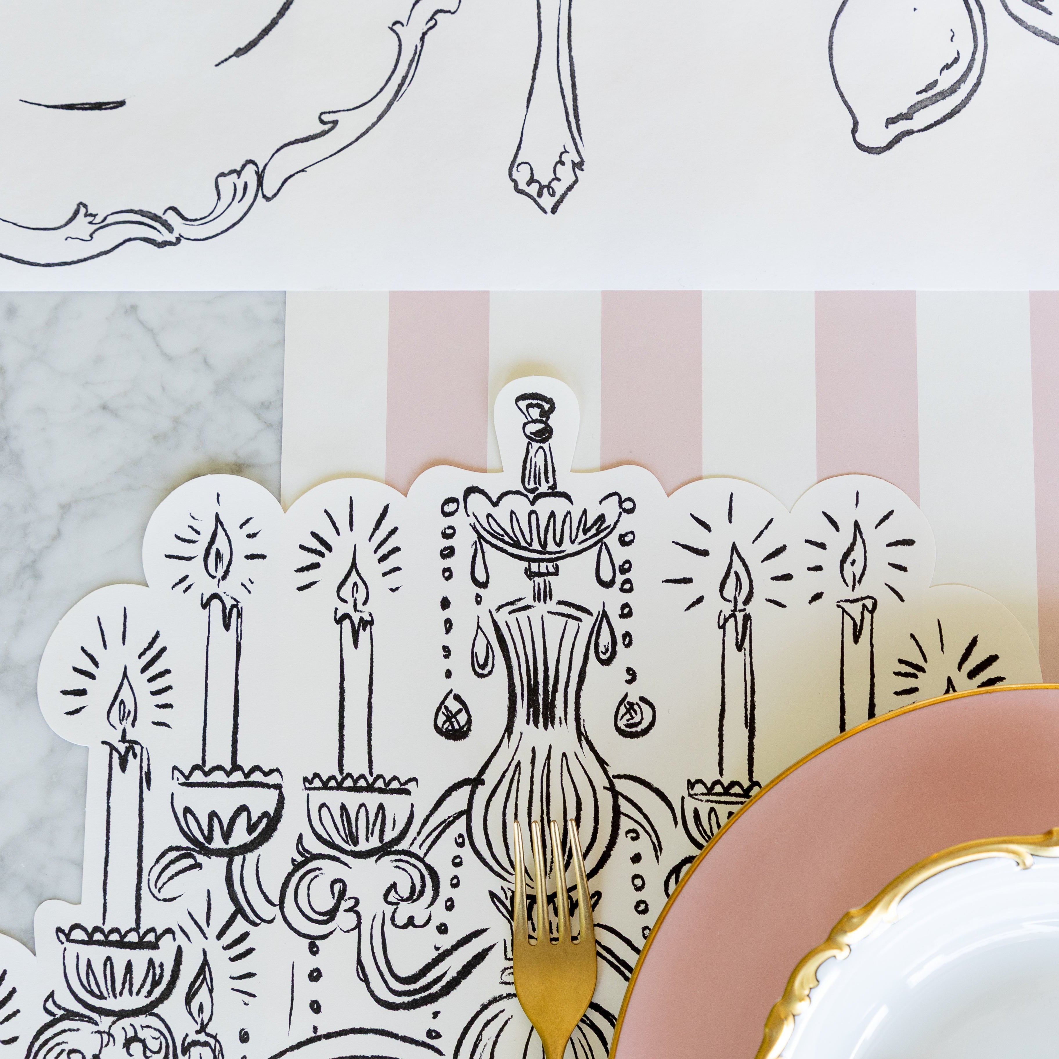A close up of the Die-cut Chandelier Placemat under an elegant place setting.