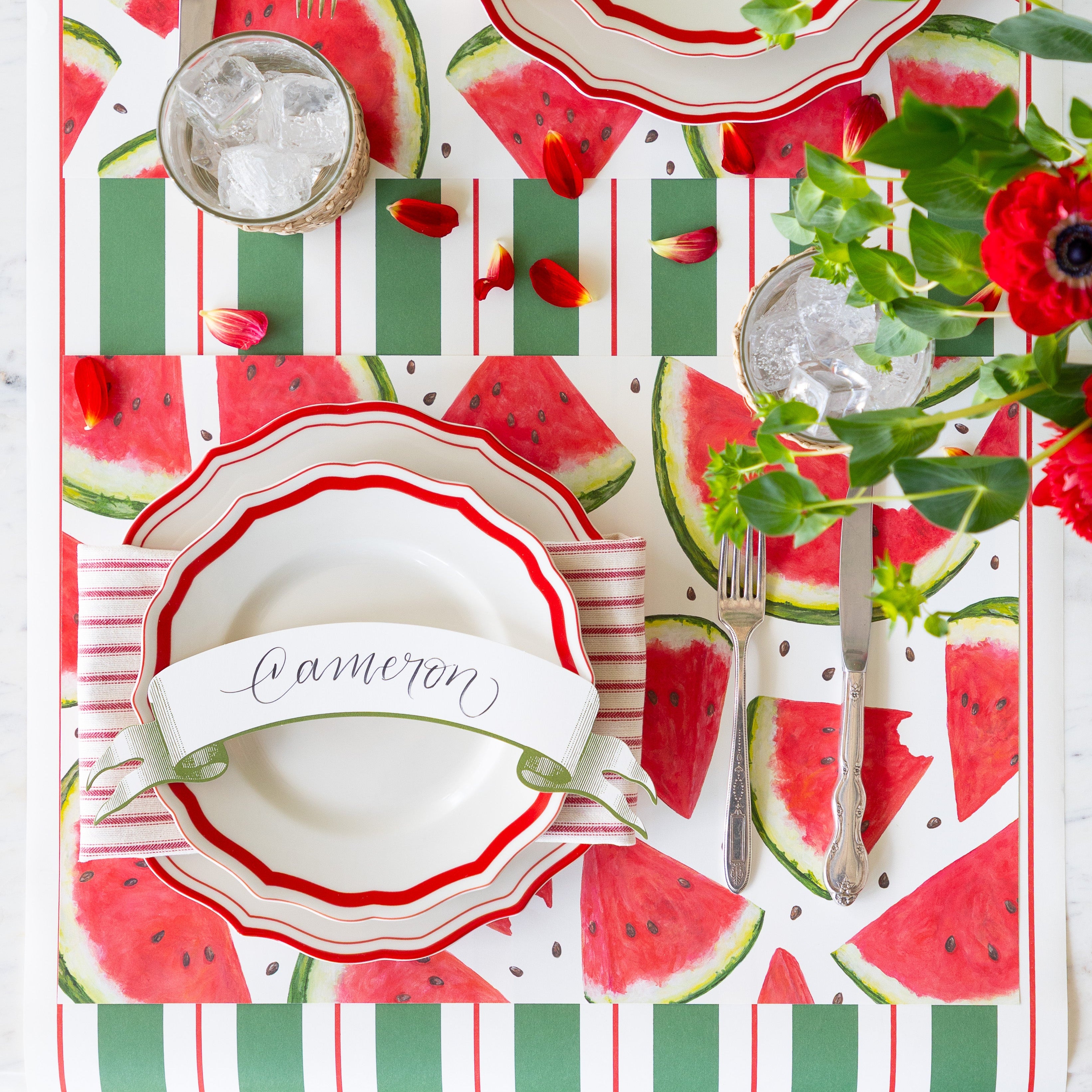 Table setting with the Watermelon Picnic Placemat, Red Icing on the Cake Dinnerware, Classic Moss Banner Table Accent and vintage flatware on the Green & Red Awning Stripe Runner.