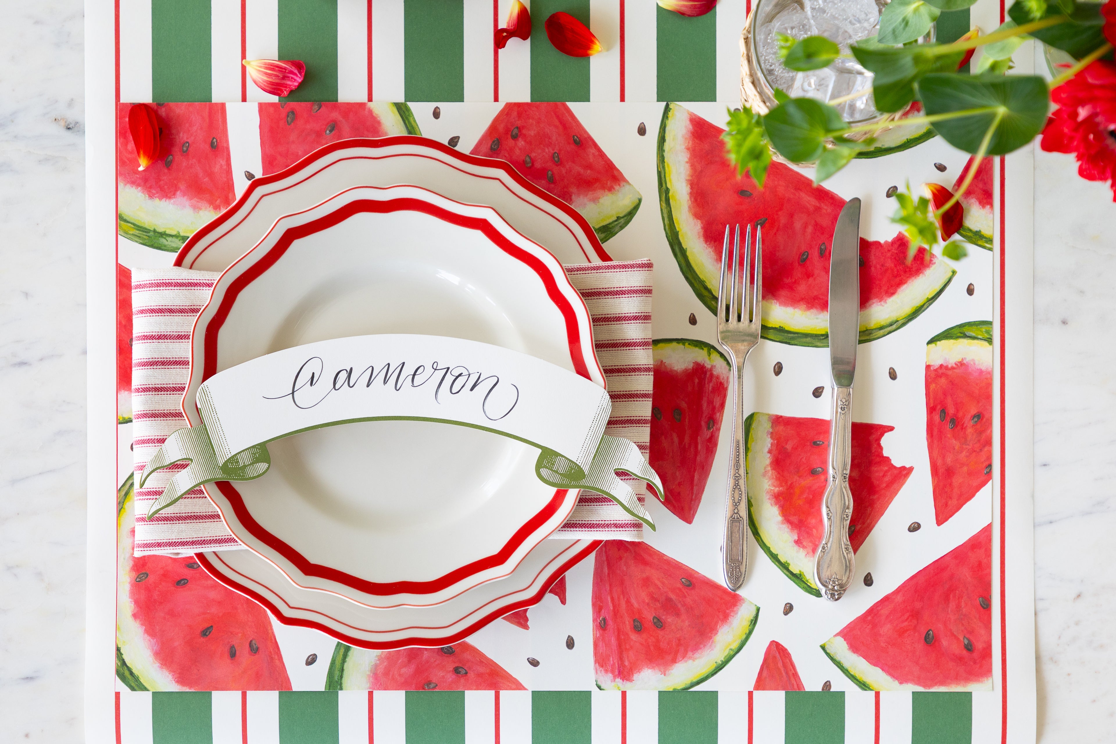 Table setting with the Watermelon Picnic Placemat, Red Icing on the Cake Dinnerware, Classic Moss Banner Table Accent and vintage flatware on the Green & Red Awning Stripe Runner.