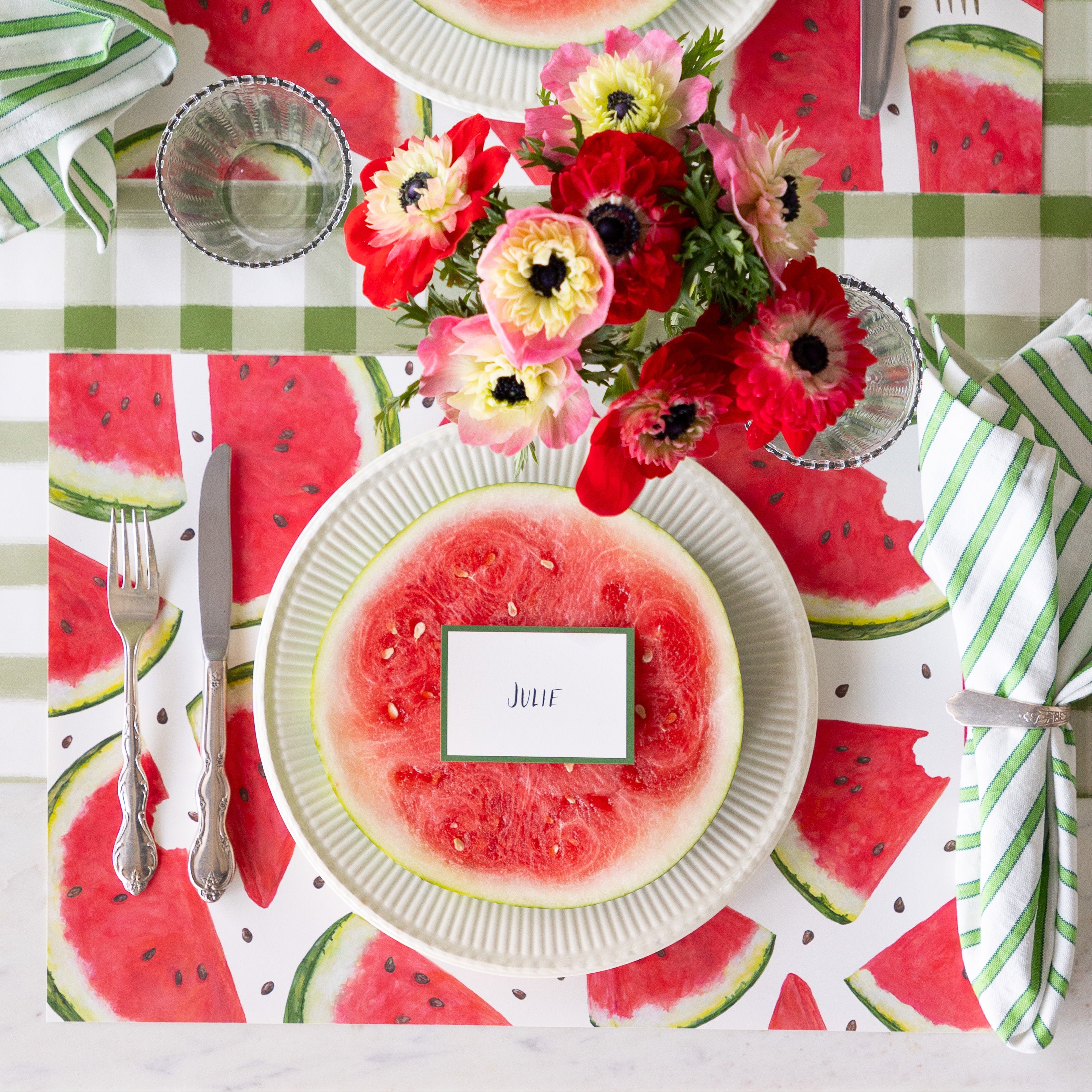 Table setting with flowers, watermelon slice, Watermelon Picnic Placemat, Dark Green Frame Place Card and vintage flatware on the Moss Painted Check Runner.