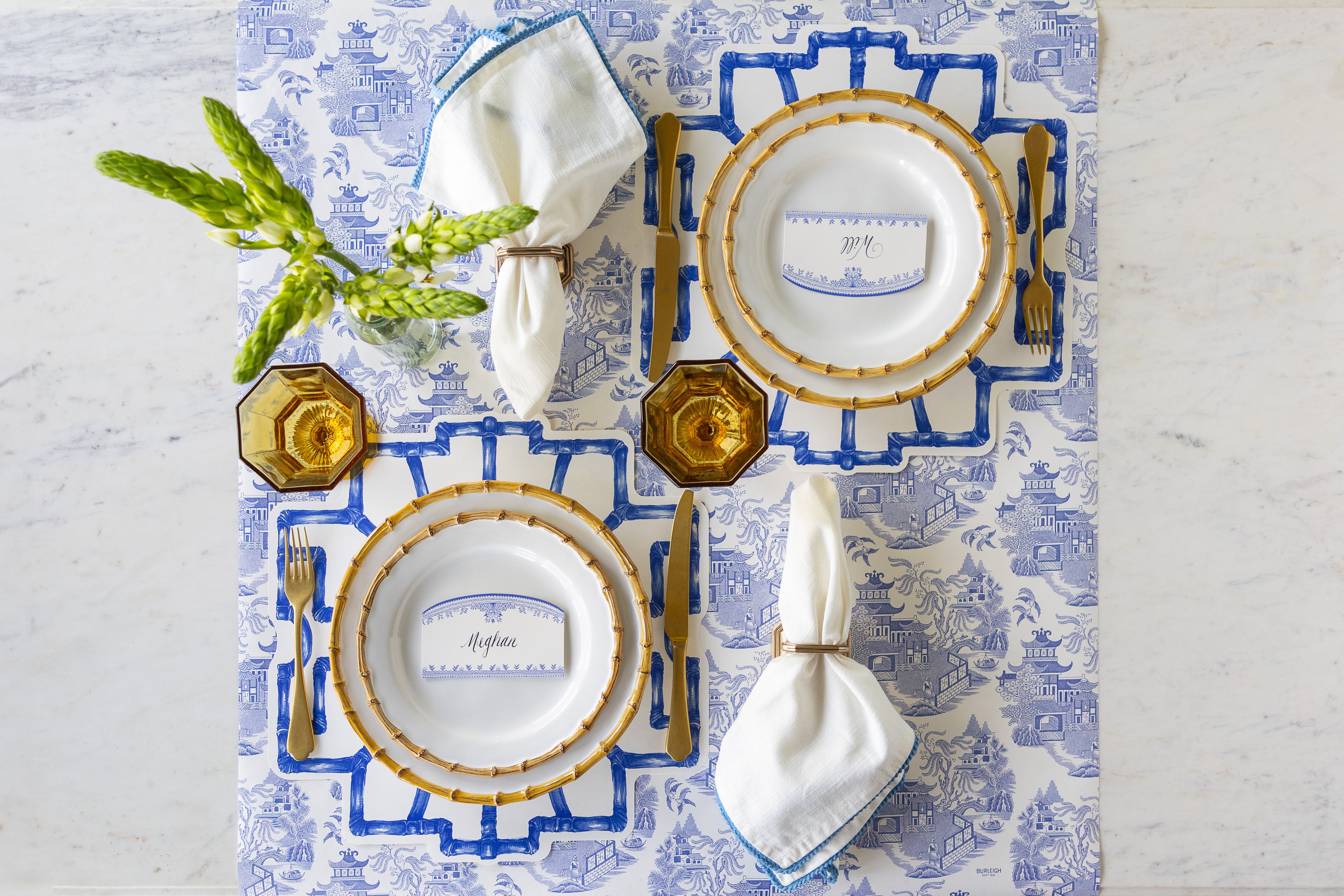 Elegant table setting with Die-cut Blue Bamboo Placemats, Juliska Bamboo plates, gold flatware, Burleigh Blue Place Cards and napkins on the Blue Regal Peacock Runner.