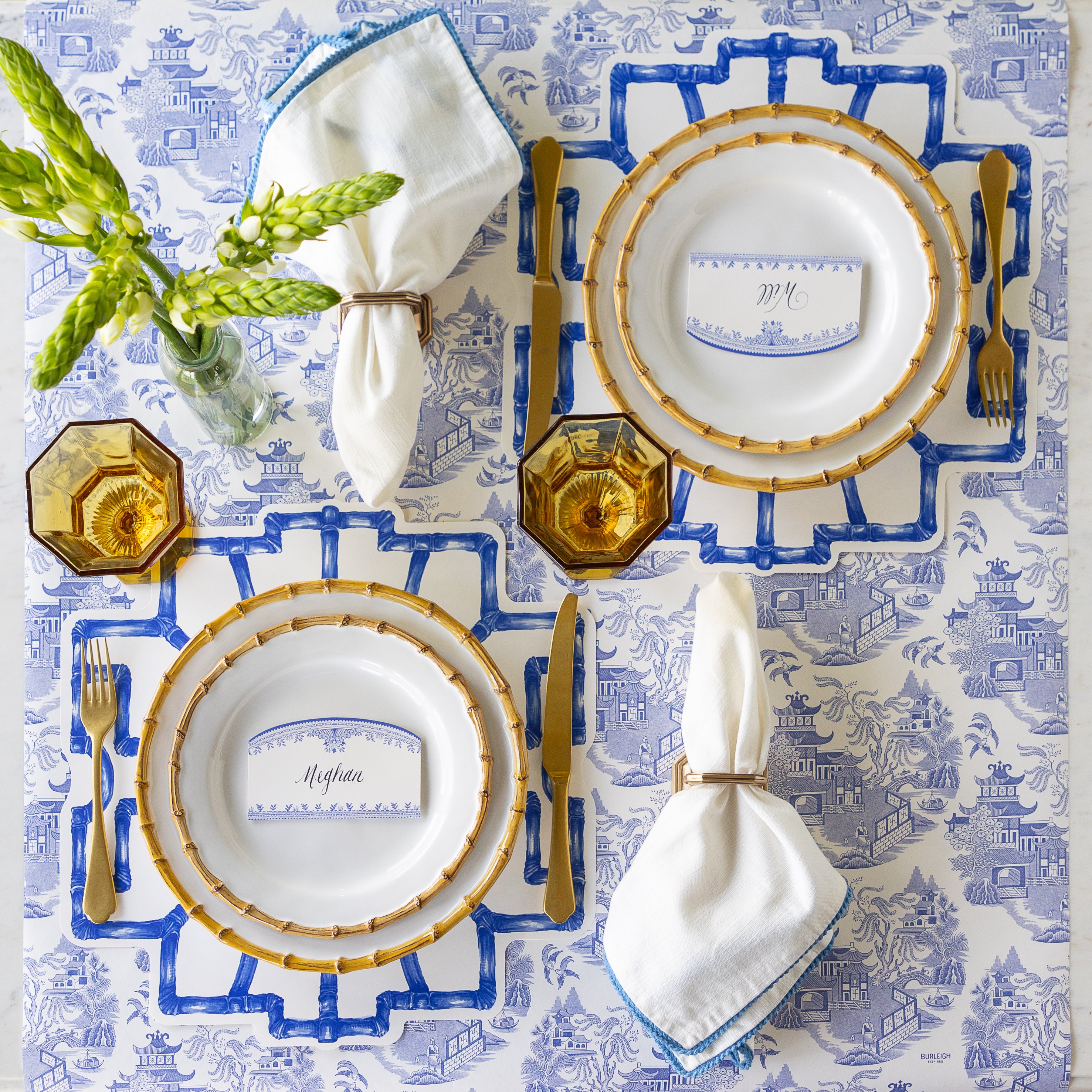 Elegant table setting with Die-cut Blue Bamboo Placemats, Juliska Bamboo plates, gold flatware, Burleigh Blue Place Cards and napkins on the Blue Regal Peacock Runner.