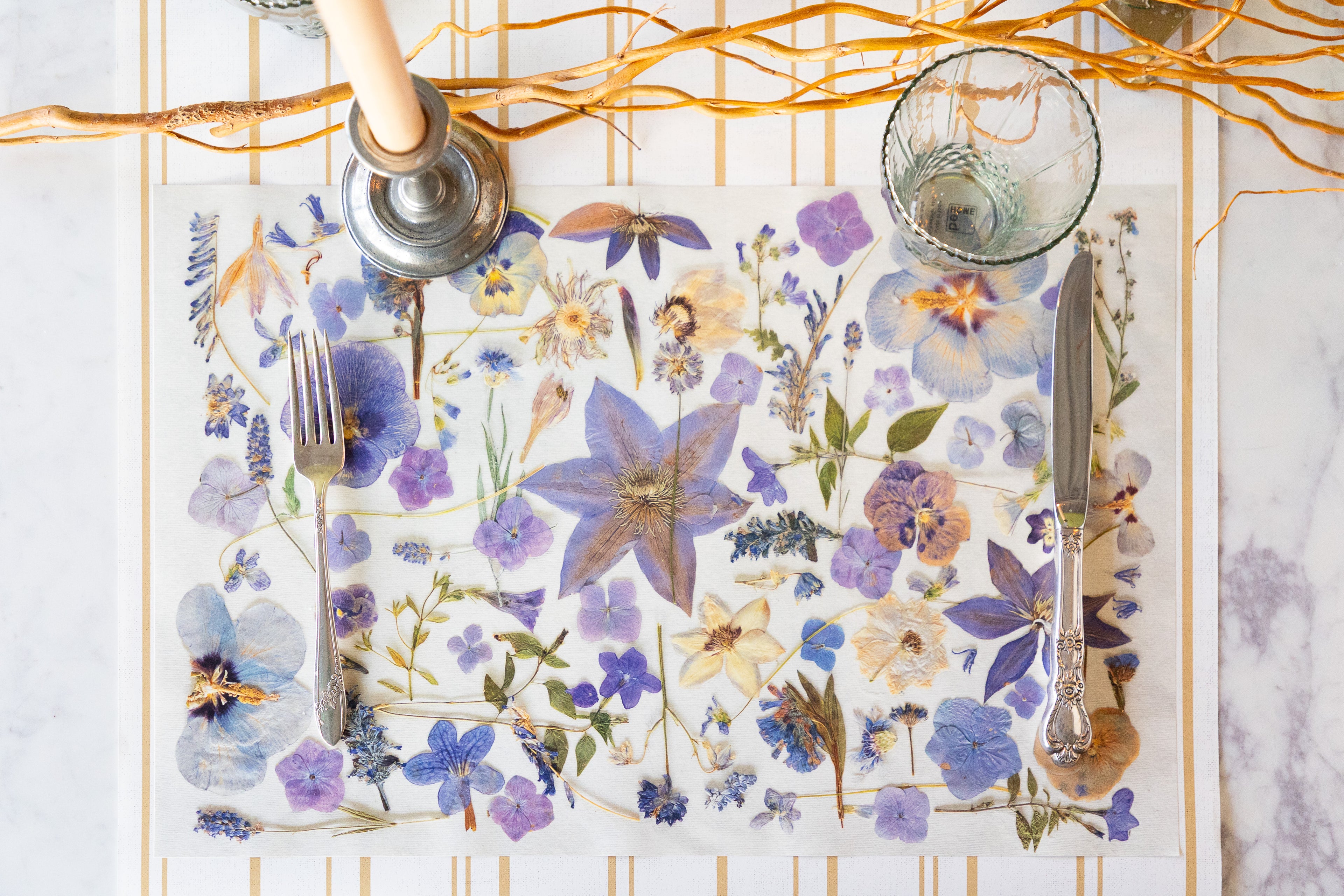 Periwinkle Pressed Petals Placemat with cutlery on a table setting.